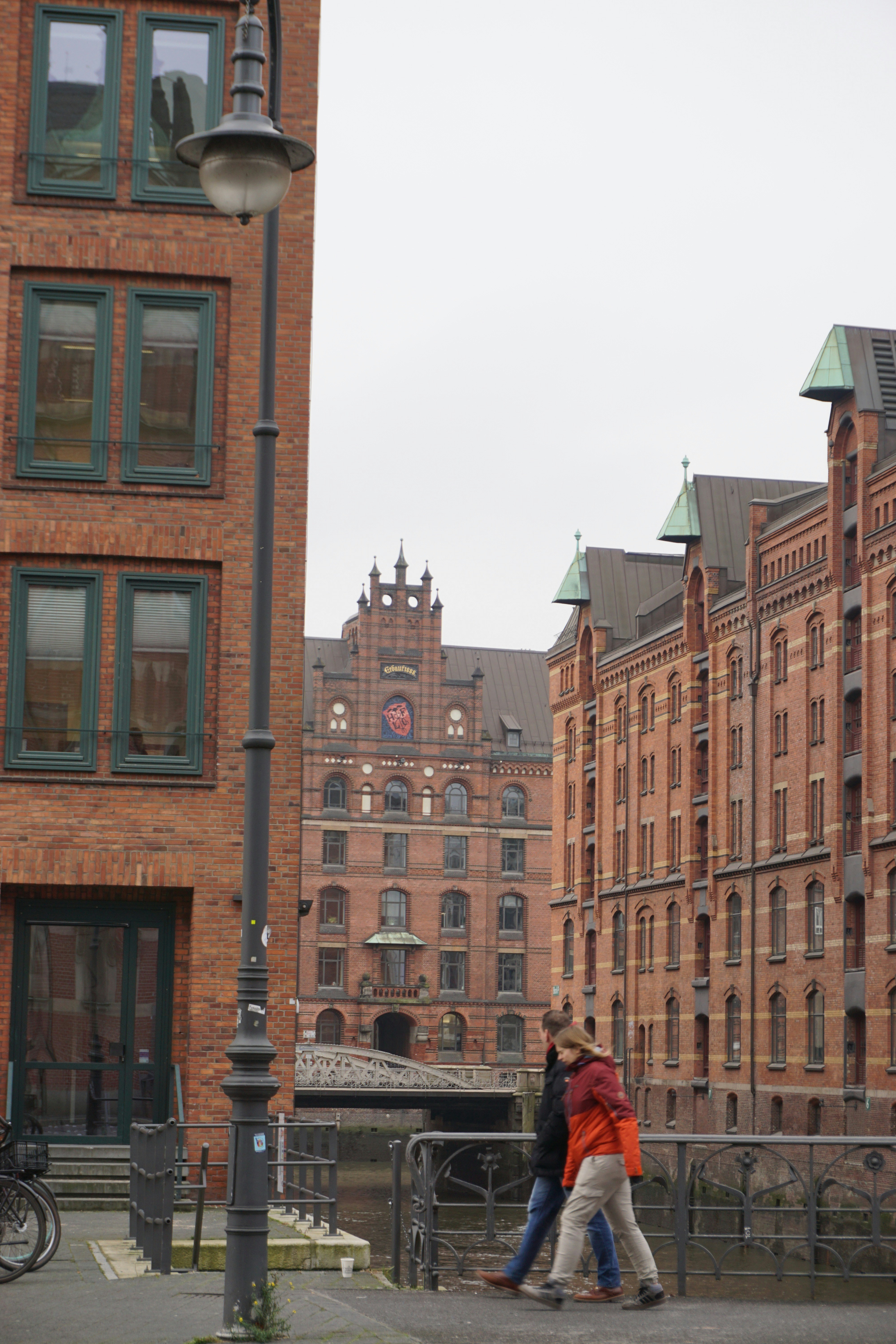 Two people walk along a canal in hamburg