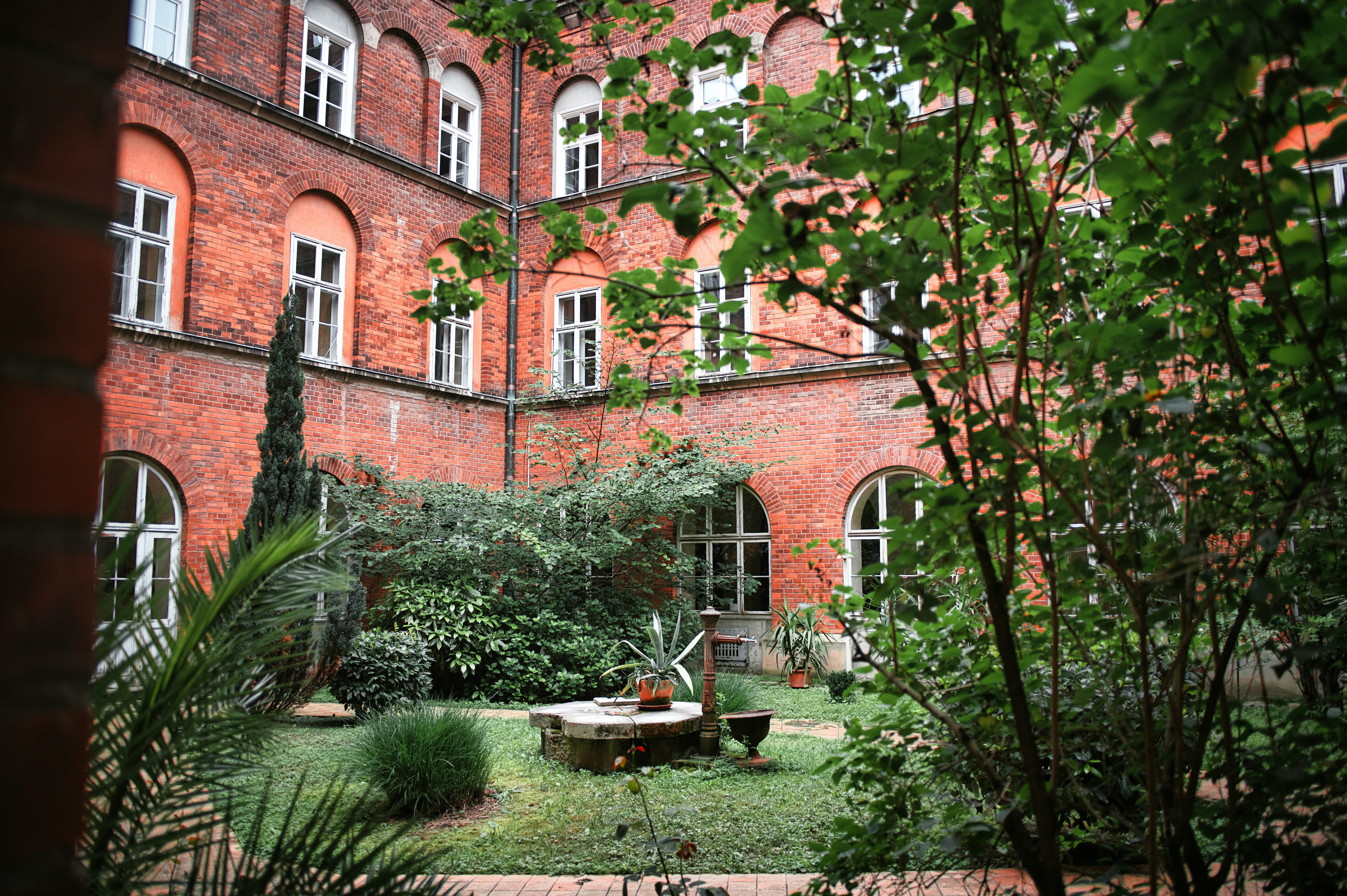 Courtyard garden with brick building and trees