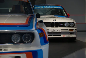 Two BMW motorsport race cars parked side by side