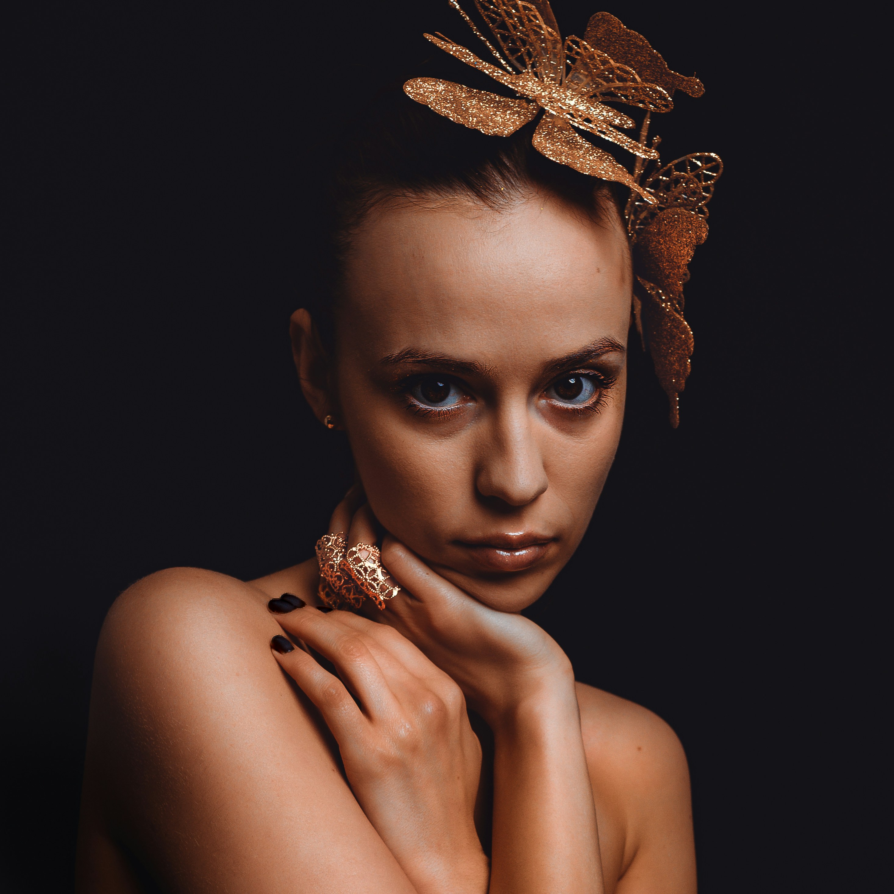 Woman with golden dragonfly headpiece and ring