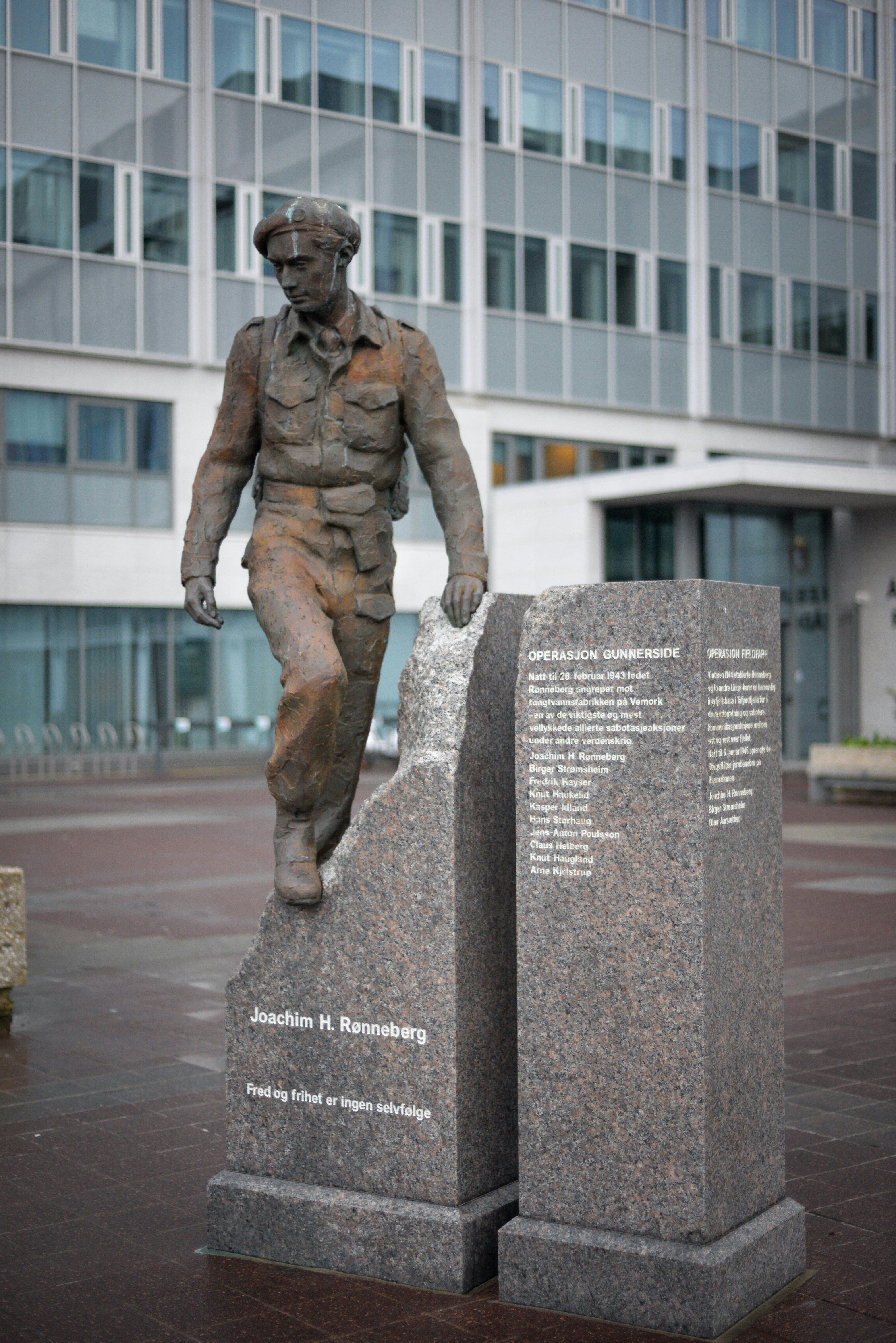 Bronze statue of a soldier on a granite monument.