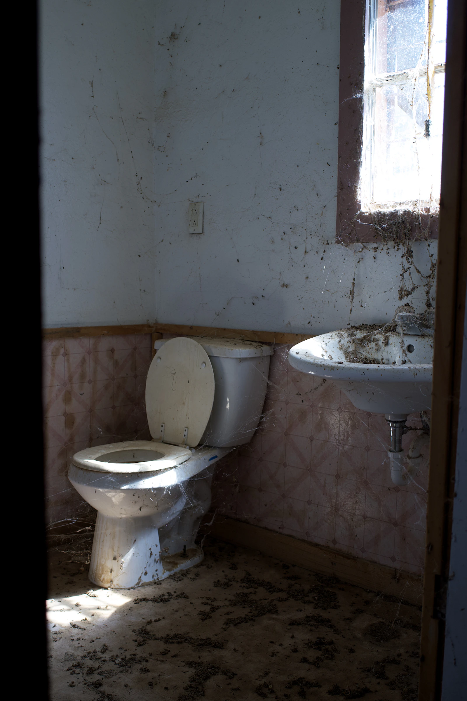 Vorher: altes Bad mit vergilbten Fliesen, Stand-WC und Waschbecken aus den Siebzigern