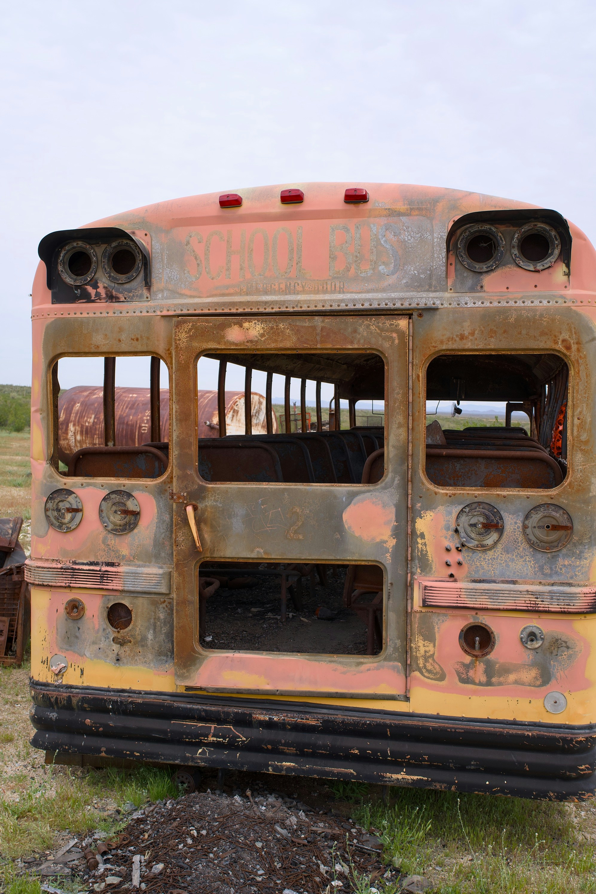 Abandoned rusty school bus in a field