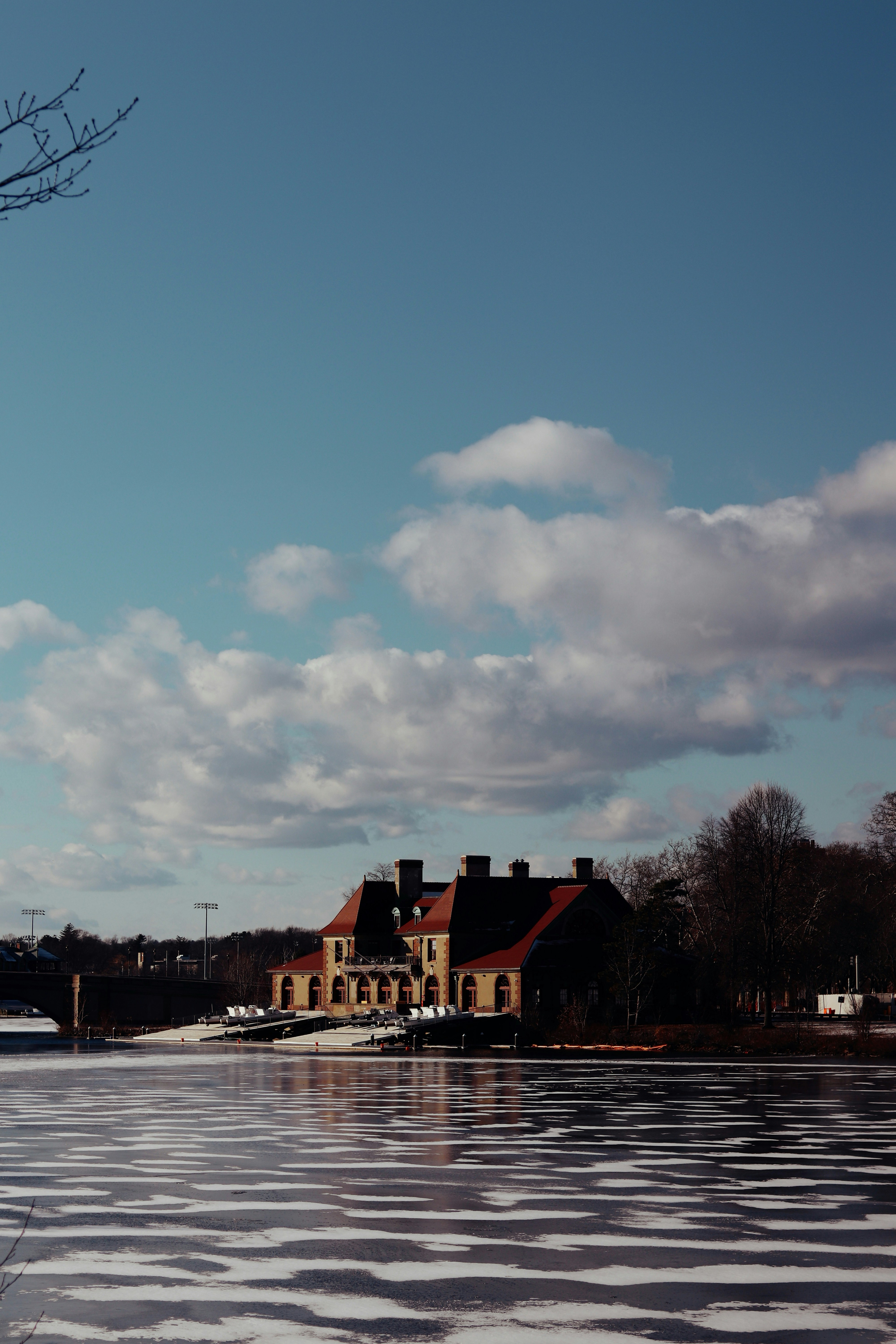 Building by a frozen lake under a cloudy sky