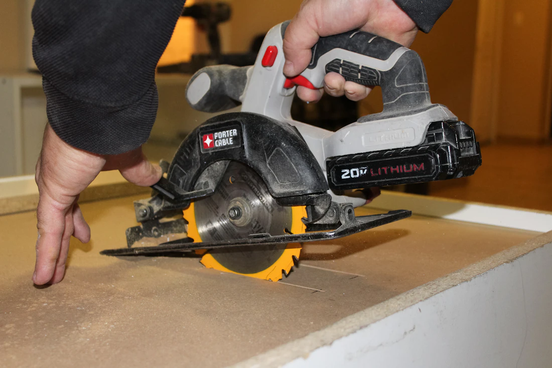 Skilled craftsperson using power tools during home improvement work