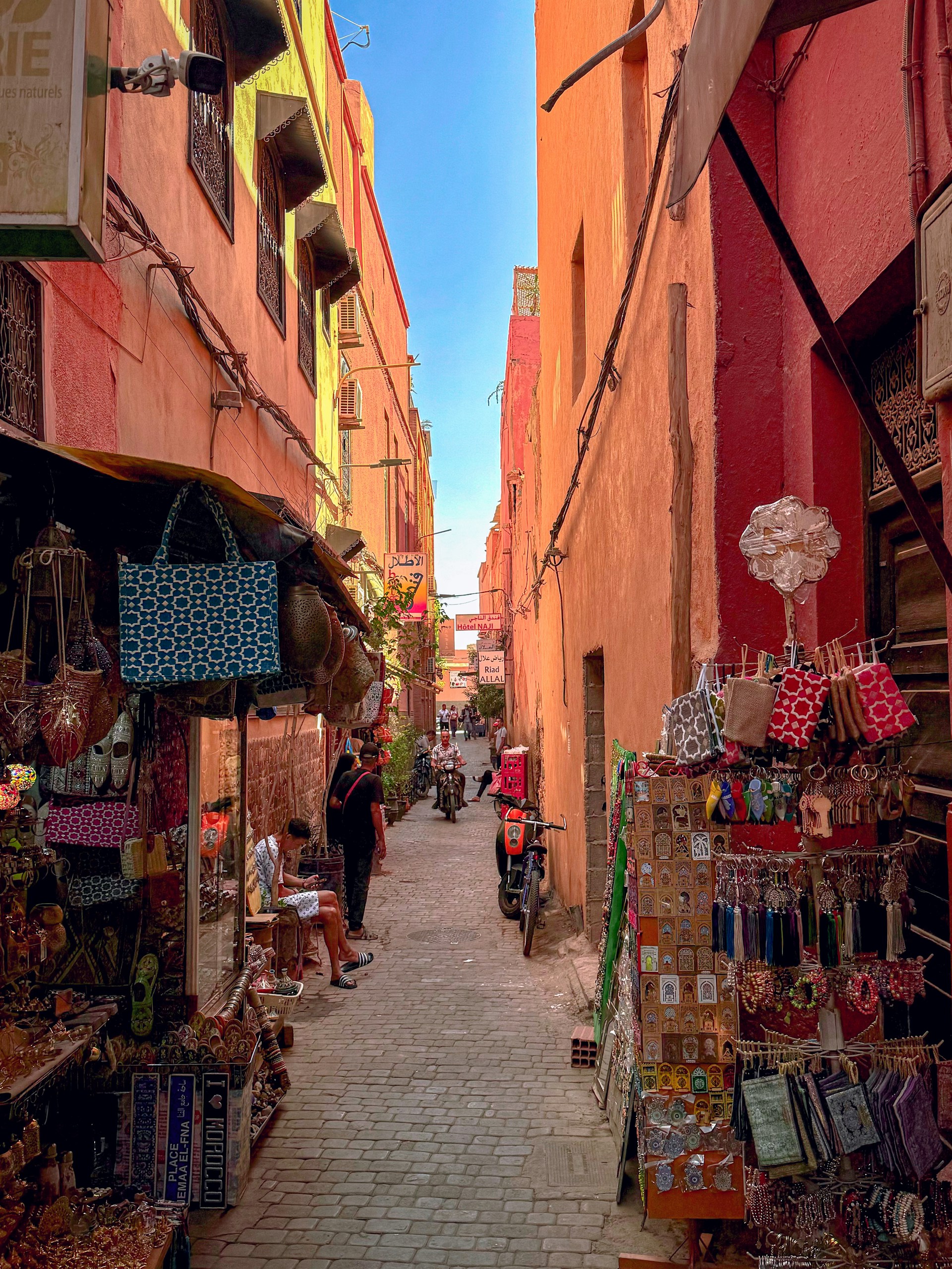 Narrow street lined with shops and people