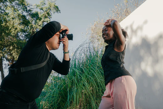 Photographer taking picture of a woman posing