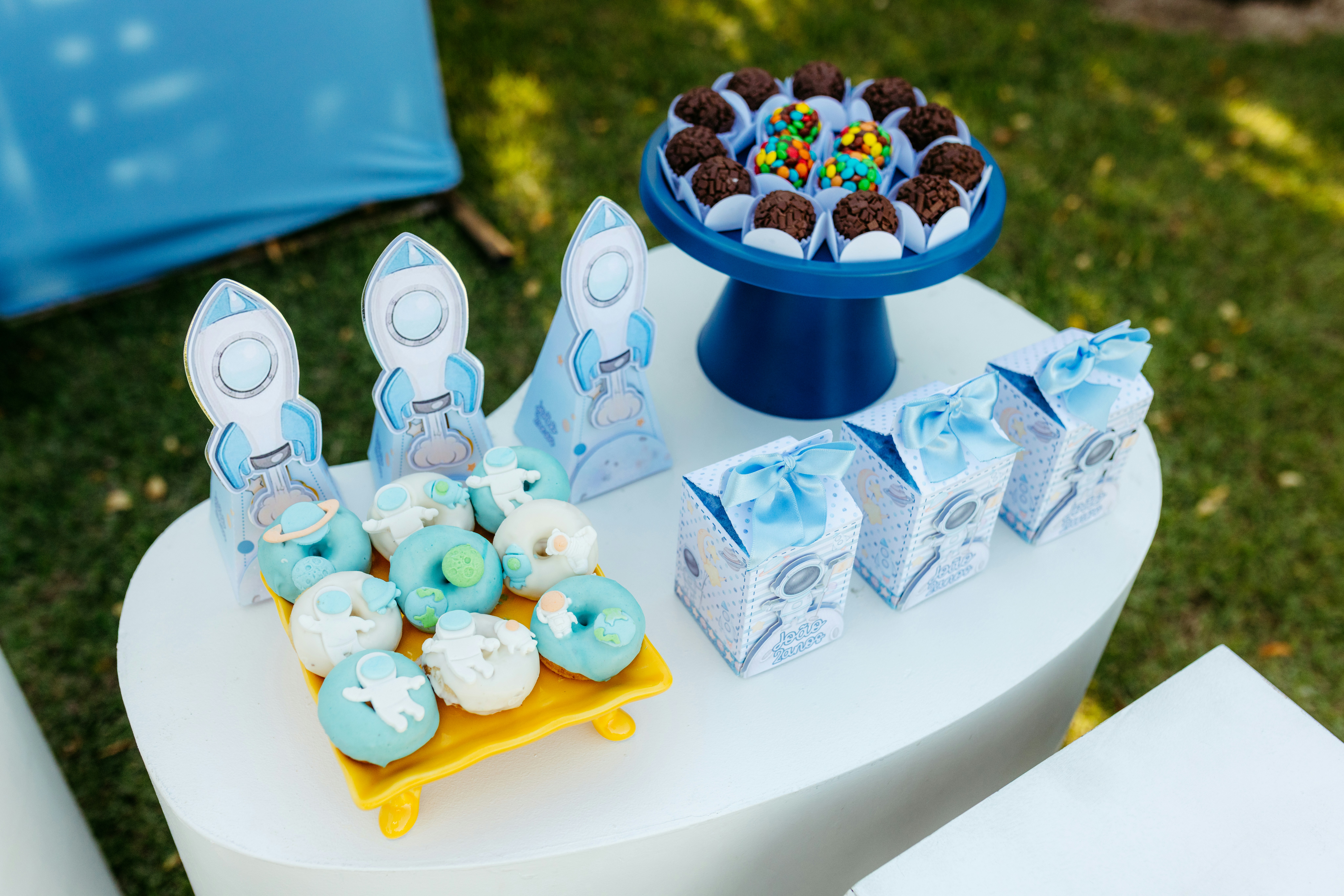Space-themed party treats with donuts and chocolates.