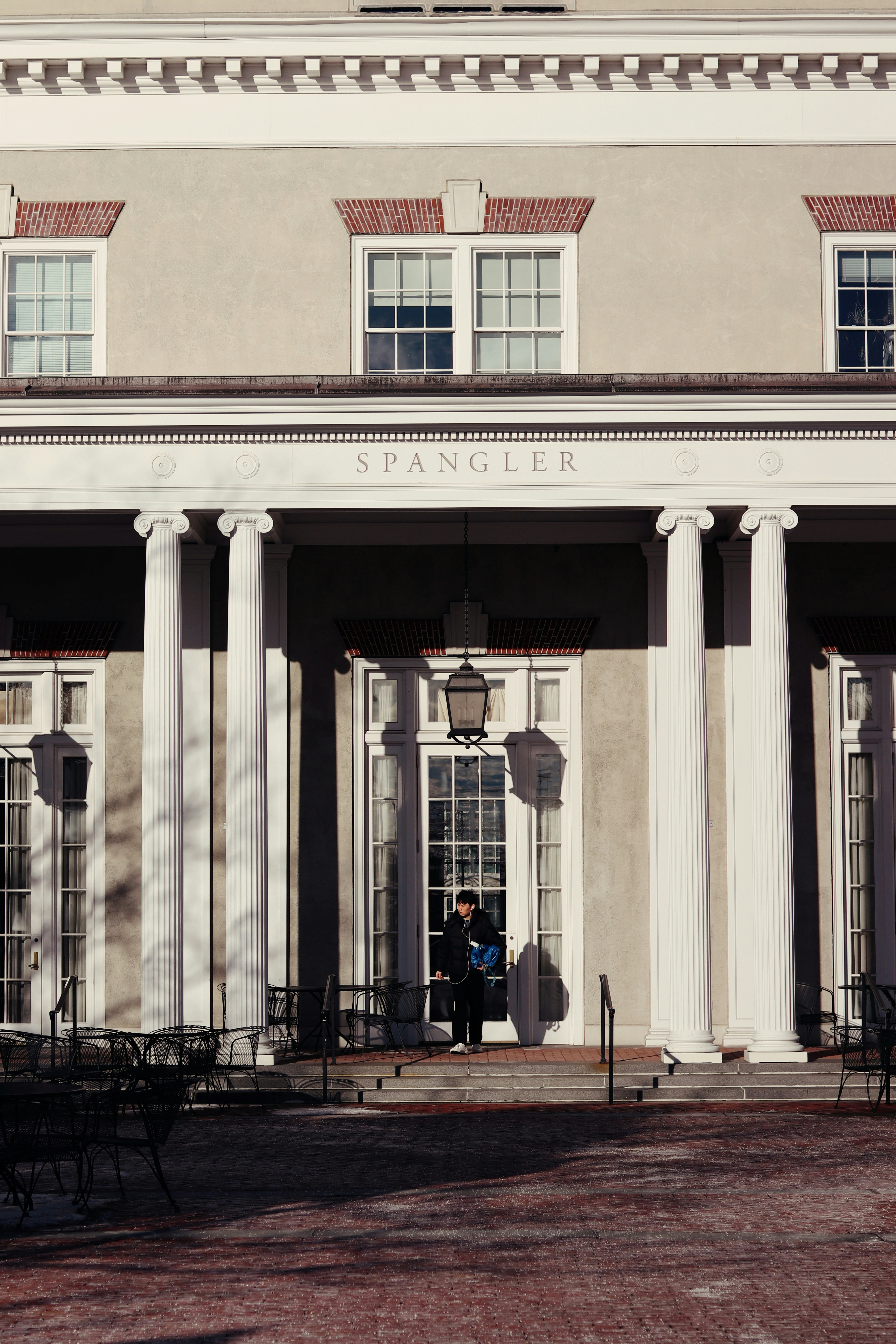 Person stands in doorway of spangler hall