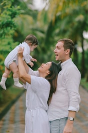 Parents holding their baby outdoors