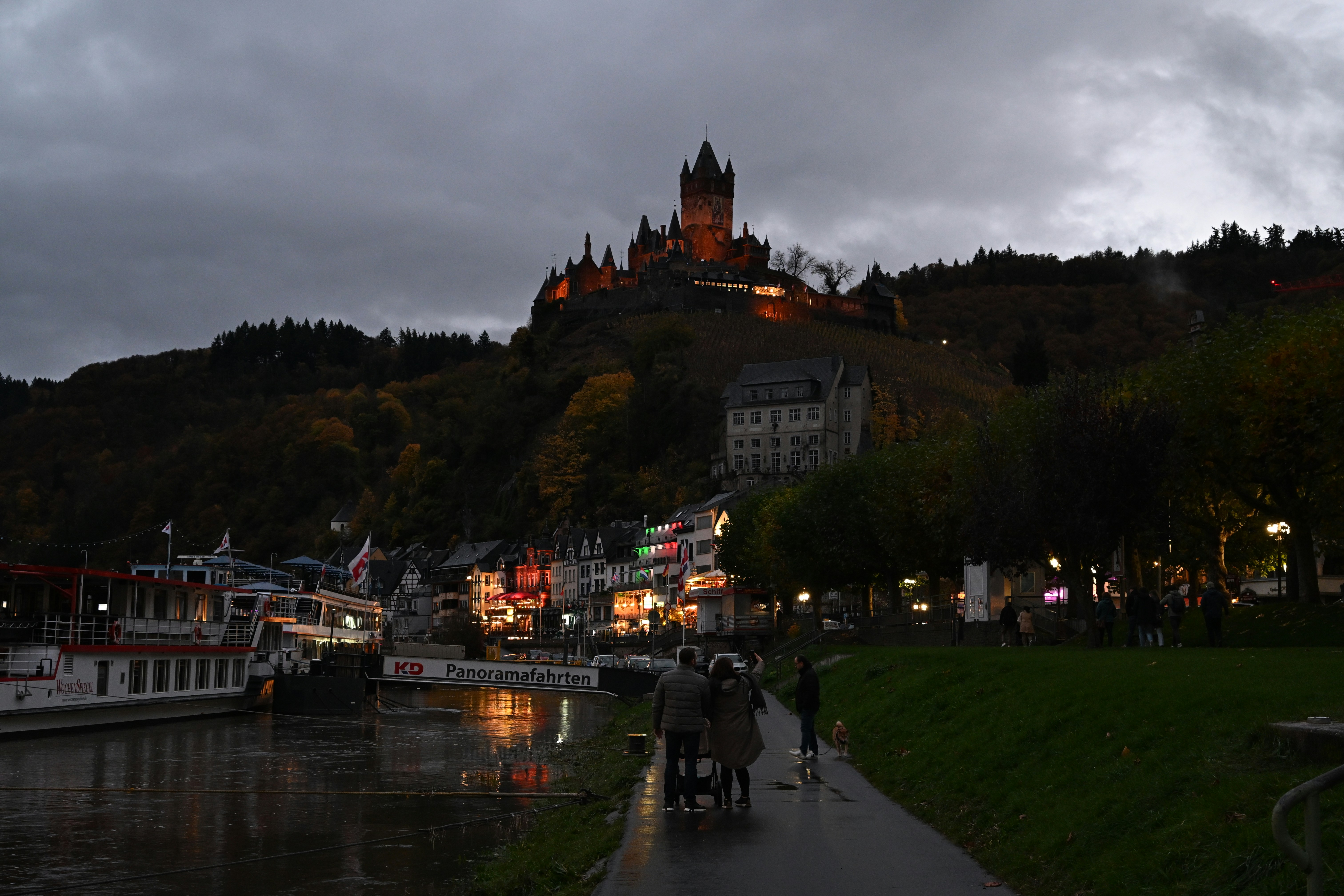 Castle on hill above town and river at dusk