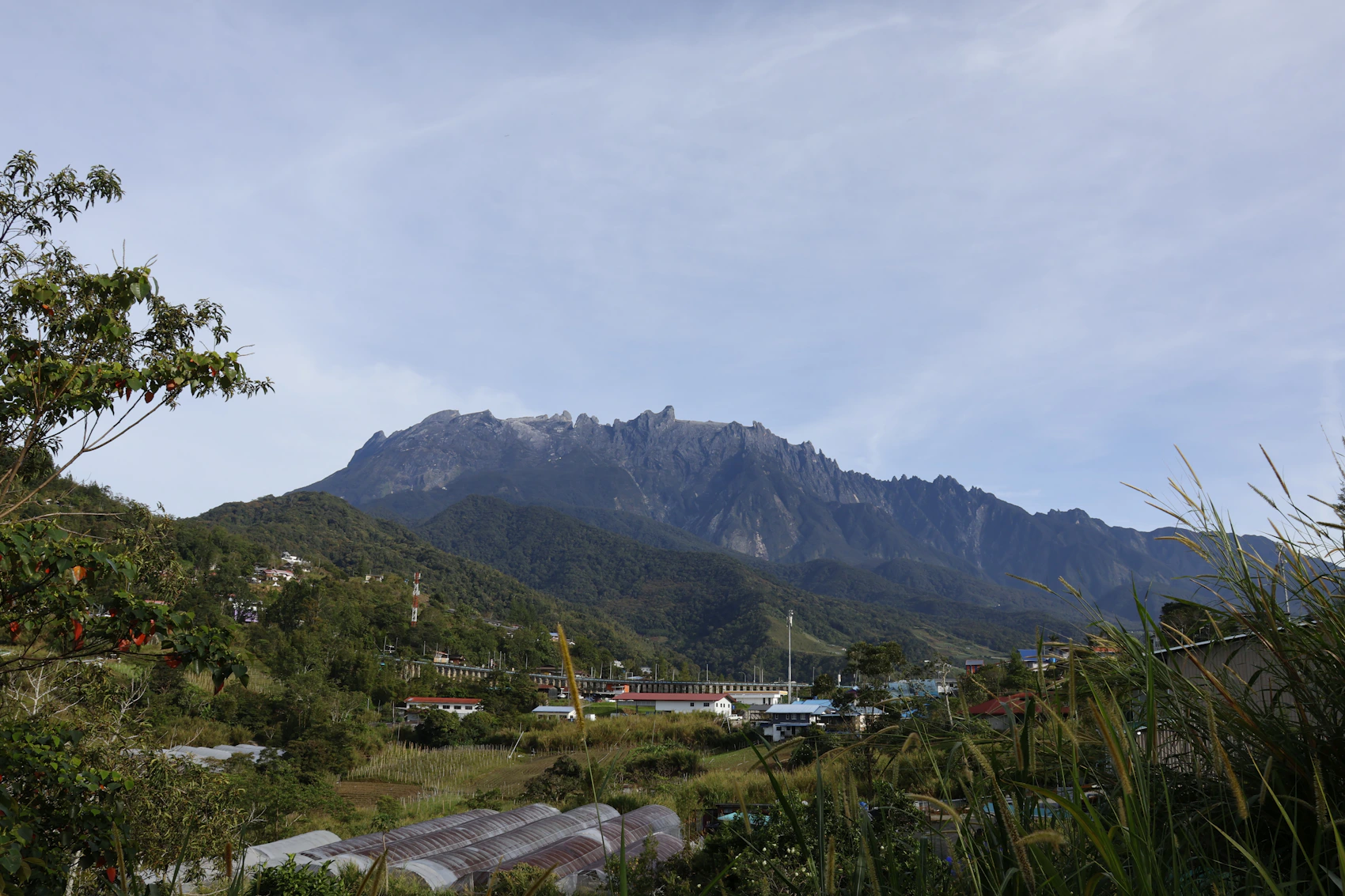 Majestic Mount Kinabalu rising above green hills in Sabah, Malaysia