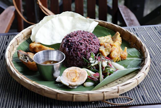 A platter of rice, egg, and other food items.