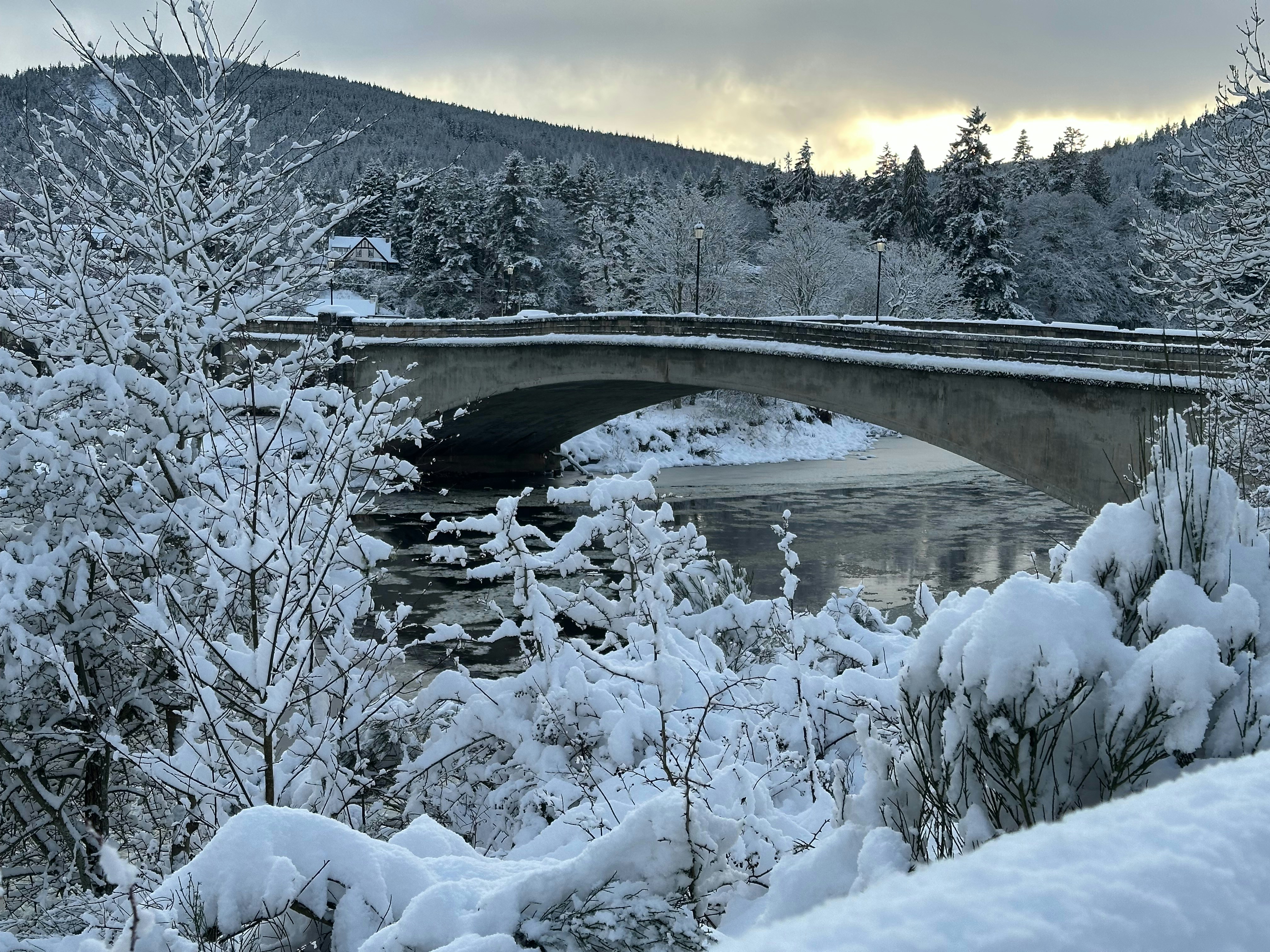 Snow-covered bridge over a river in winter