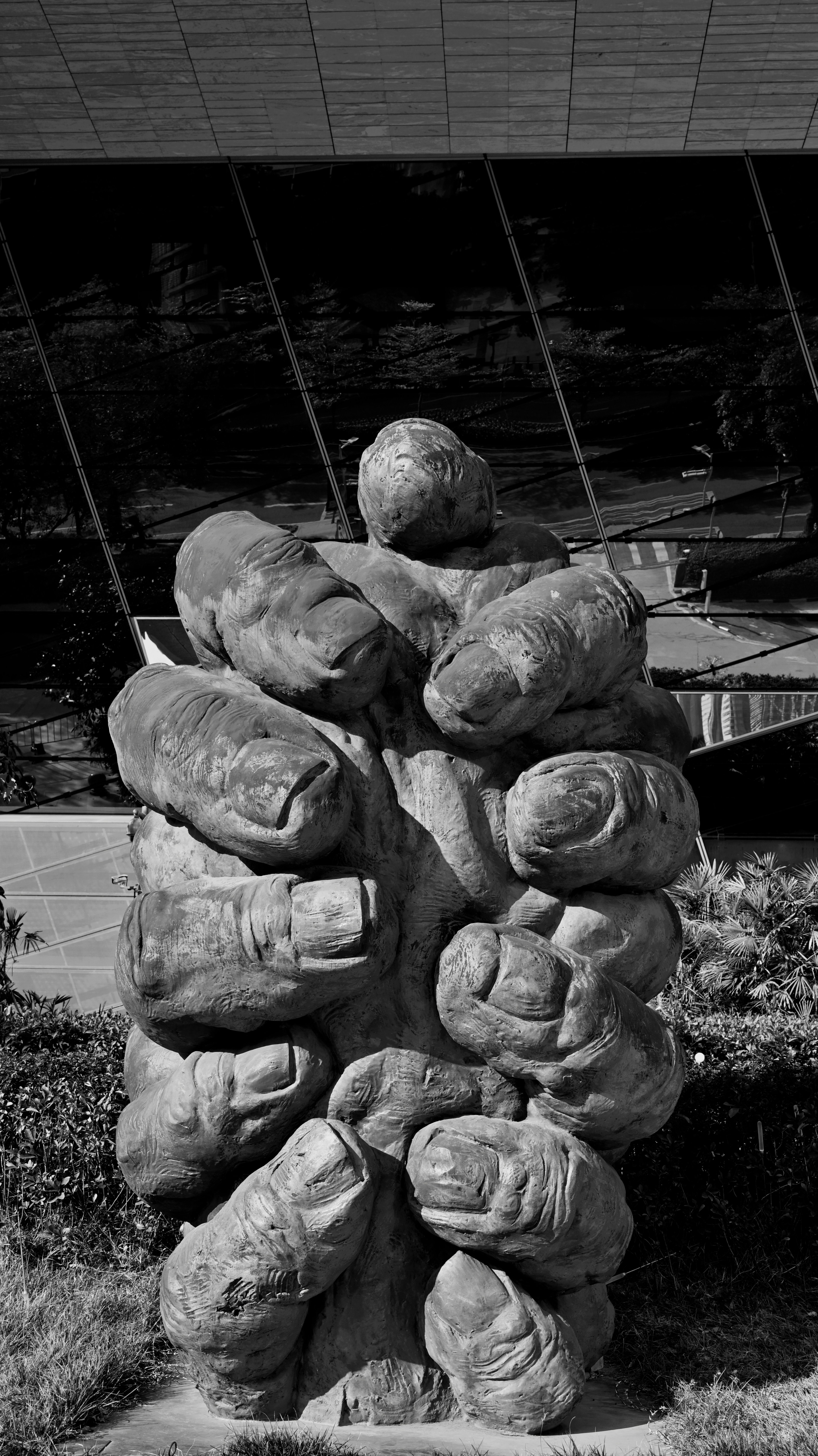 A large abstract stone sculpture of a fist.