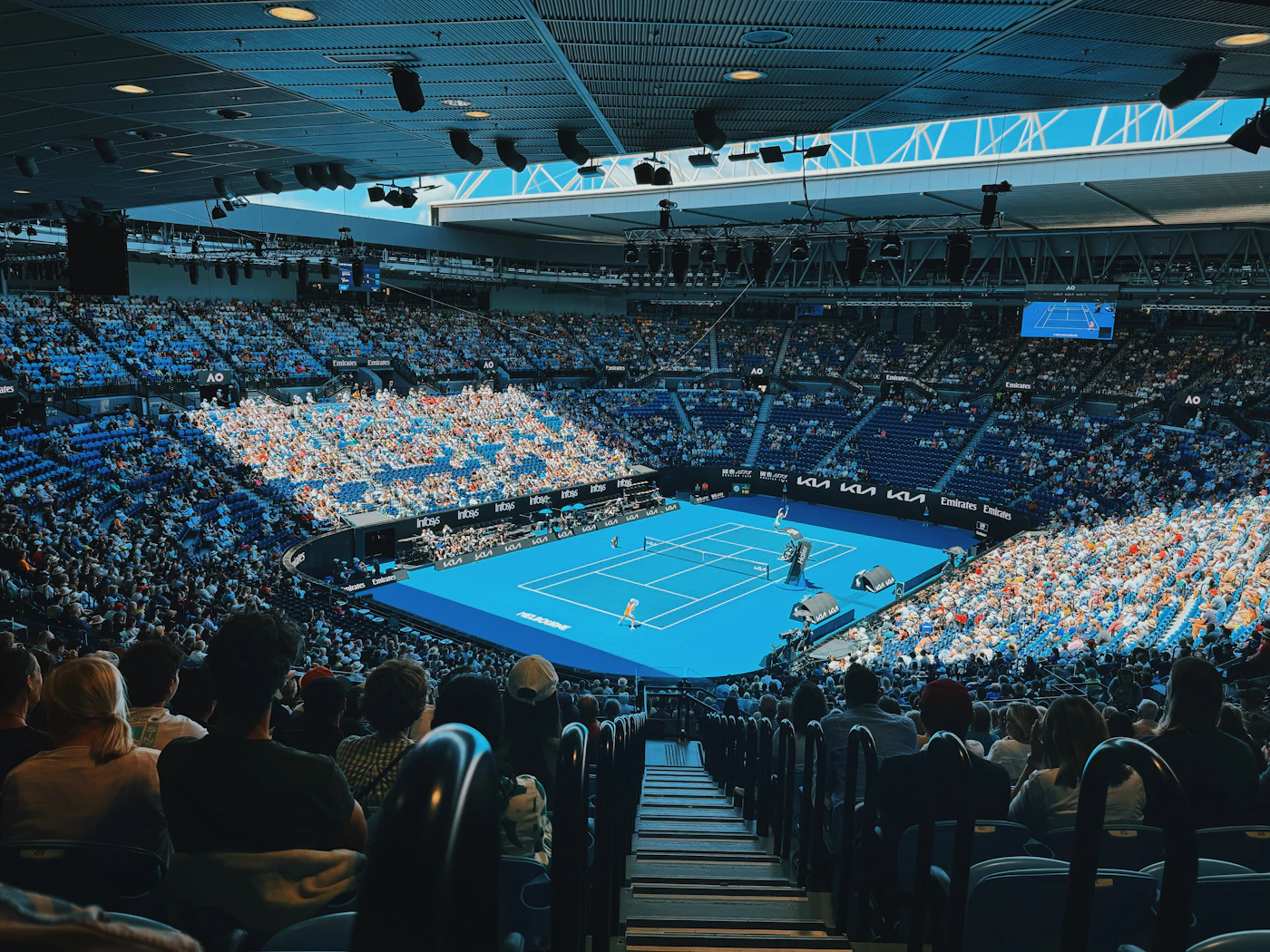 A packed tennis stadium during a match