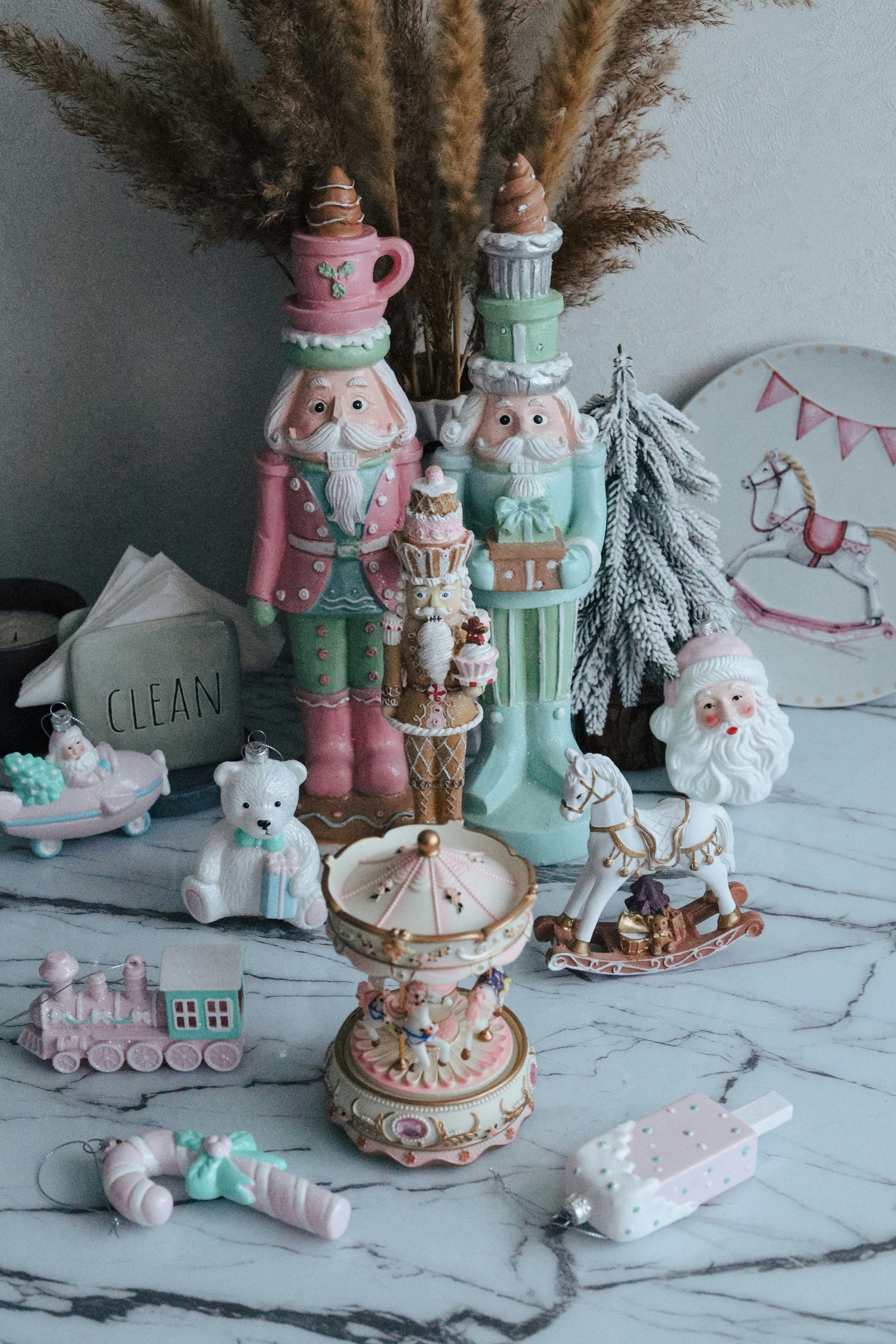 Pastel christmas ornaments on a marble surface