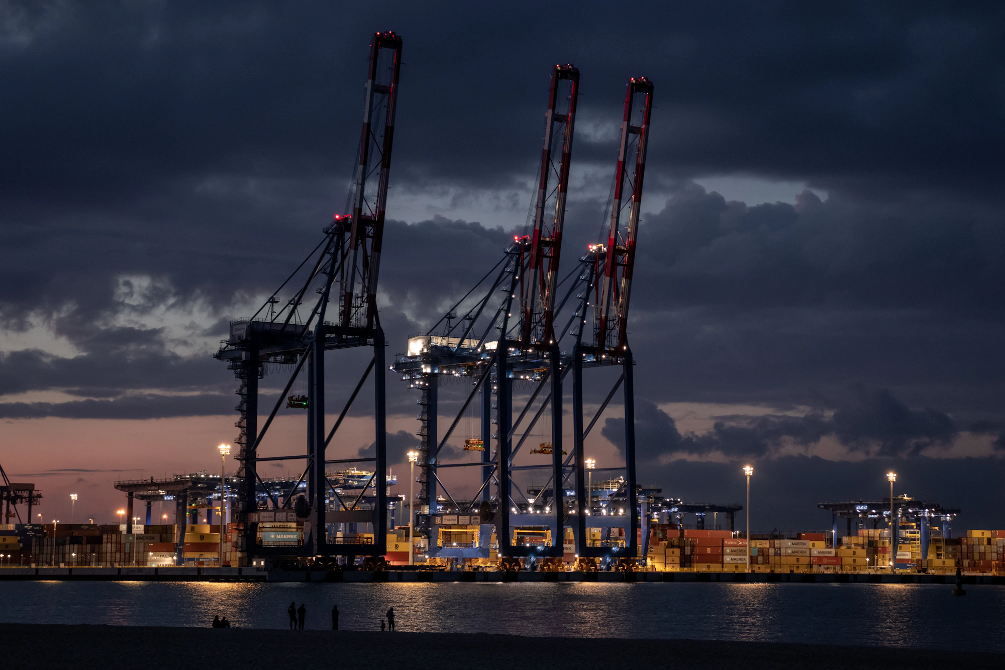 Container terminal cranes silhouetted at dusk