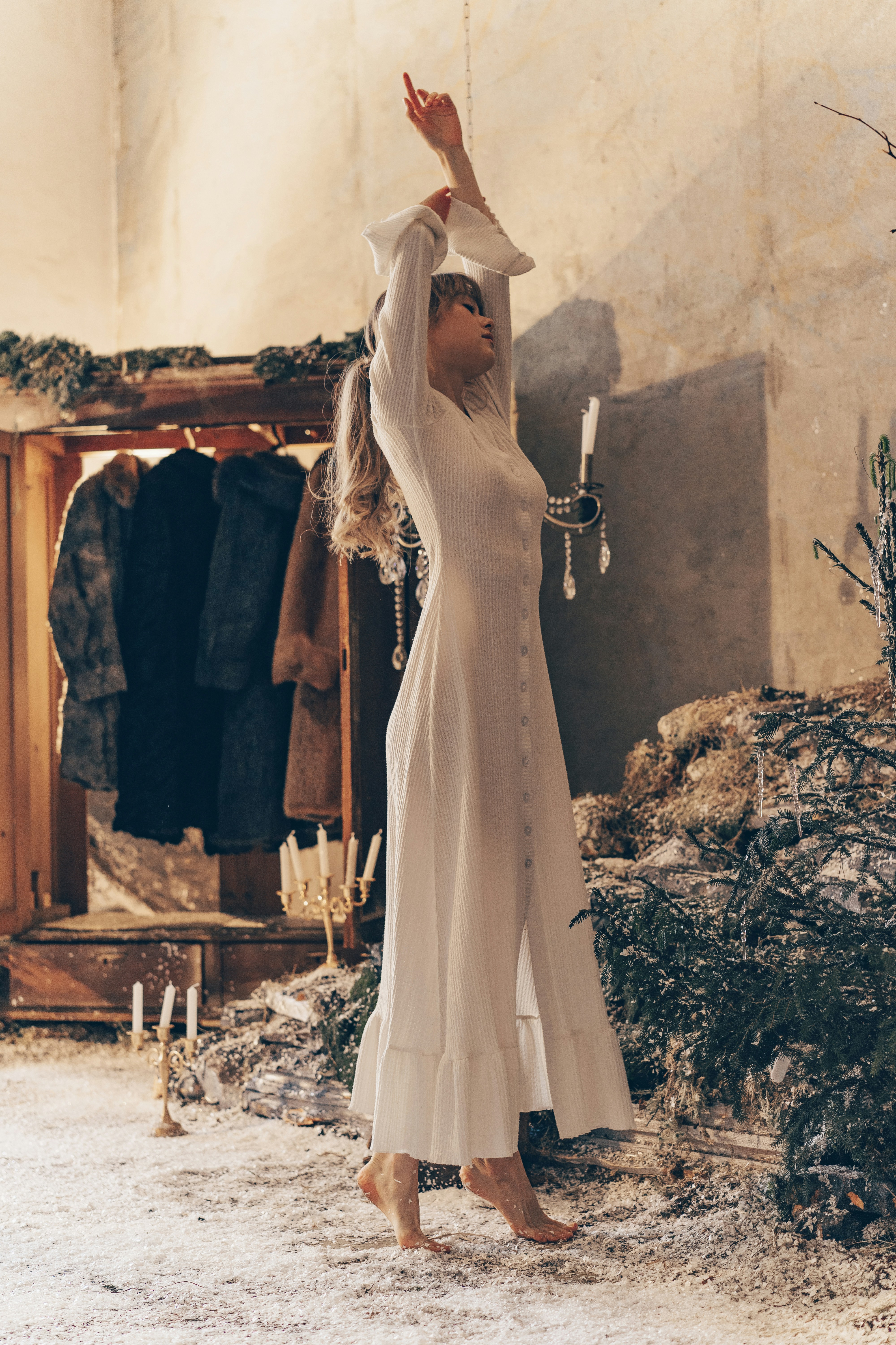 Woman in white dress with arms raised