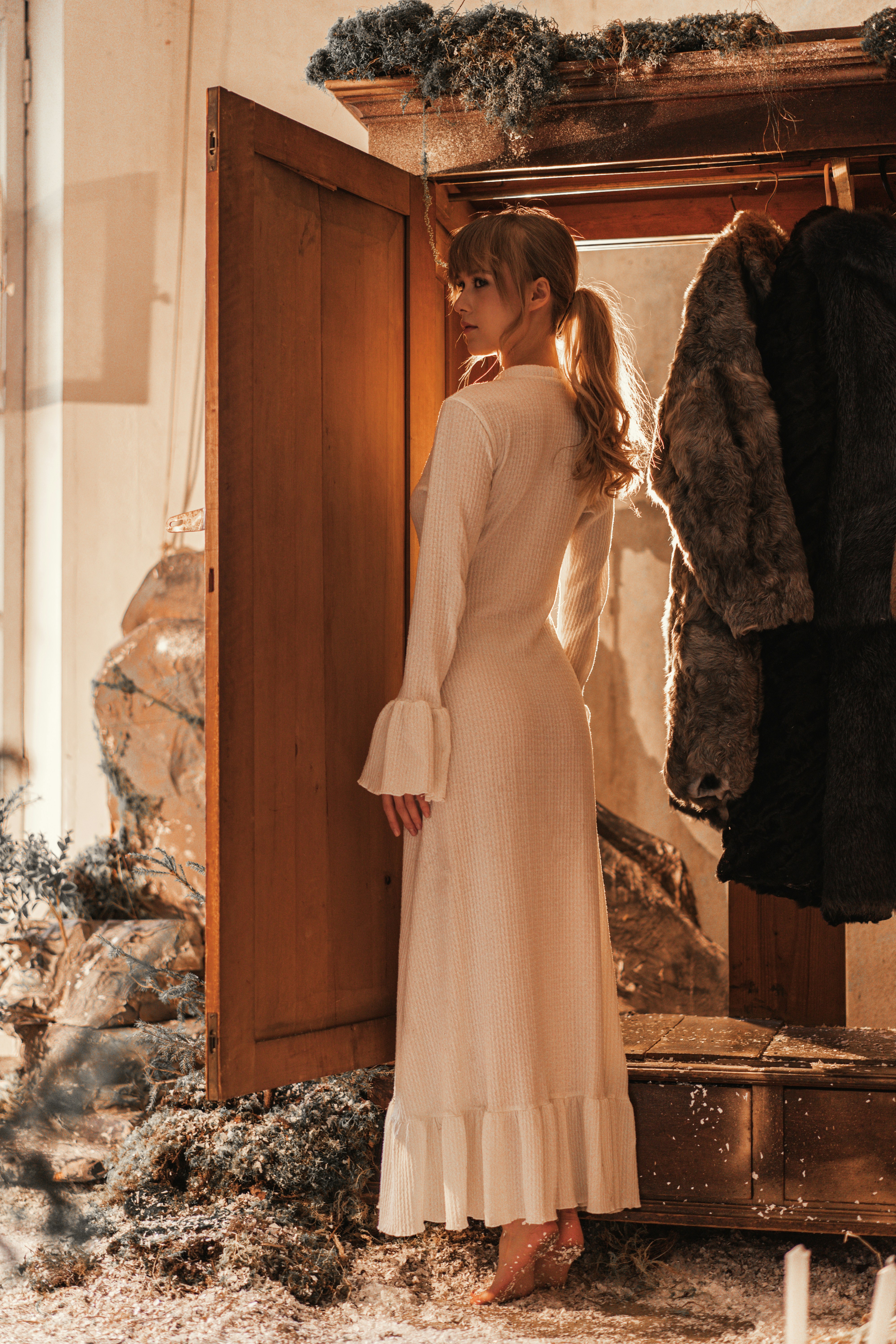 Woman in white dress looking over shoulder