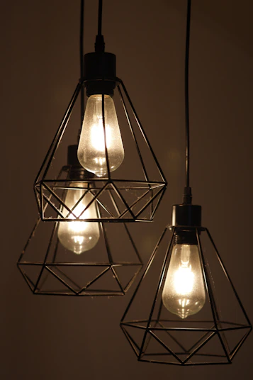 Three industrial-style pendant lights with edison bulbs