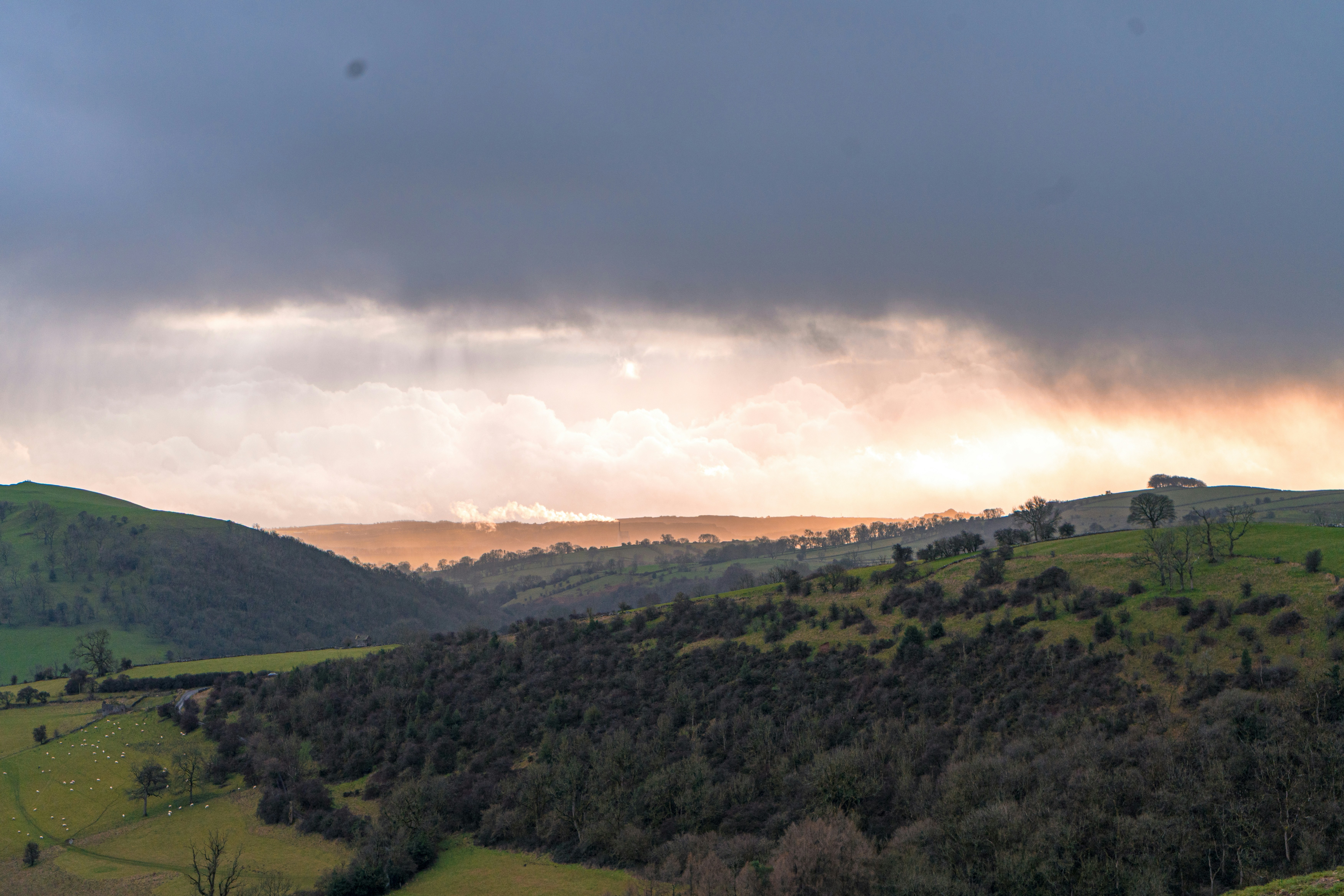 Dramatic sunset over rolling green hills