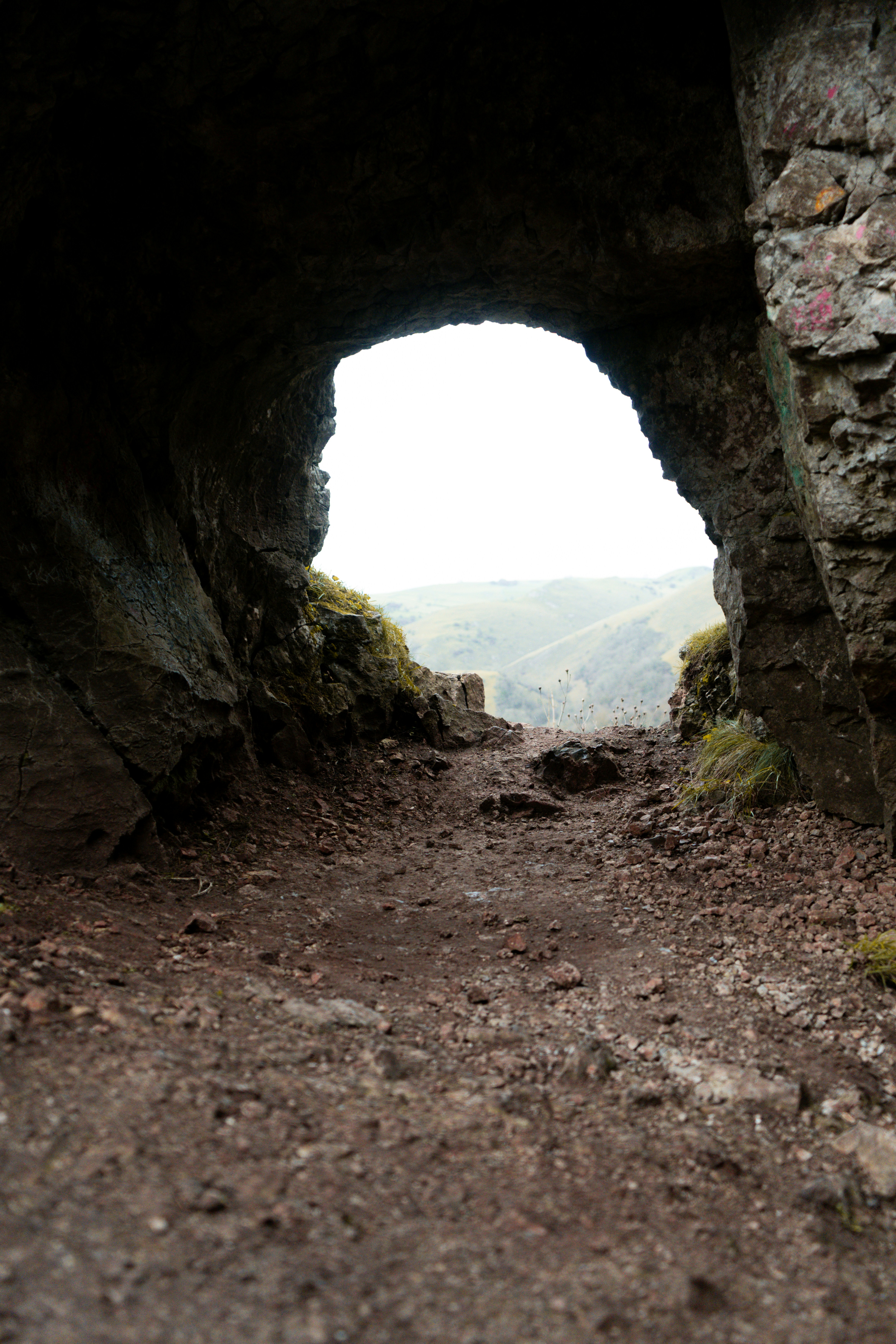 View through a stone archway to a misty landscape