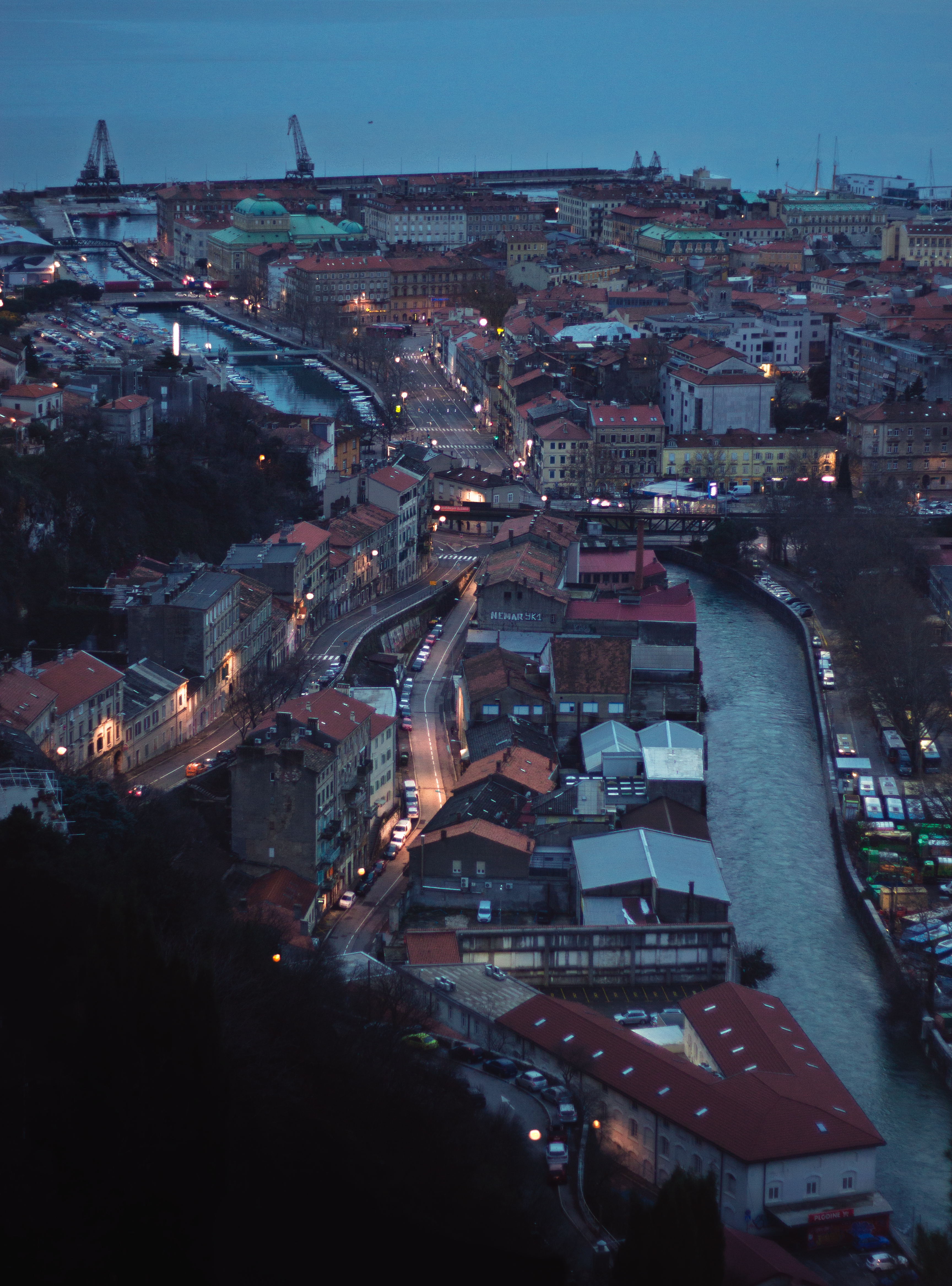 Cityscape with river and lights at dusk