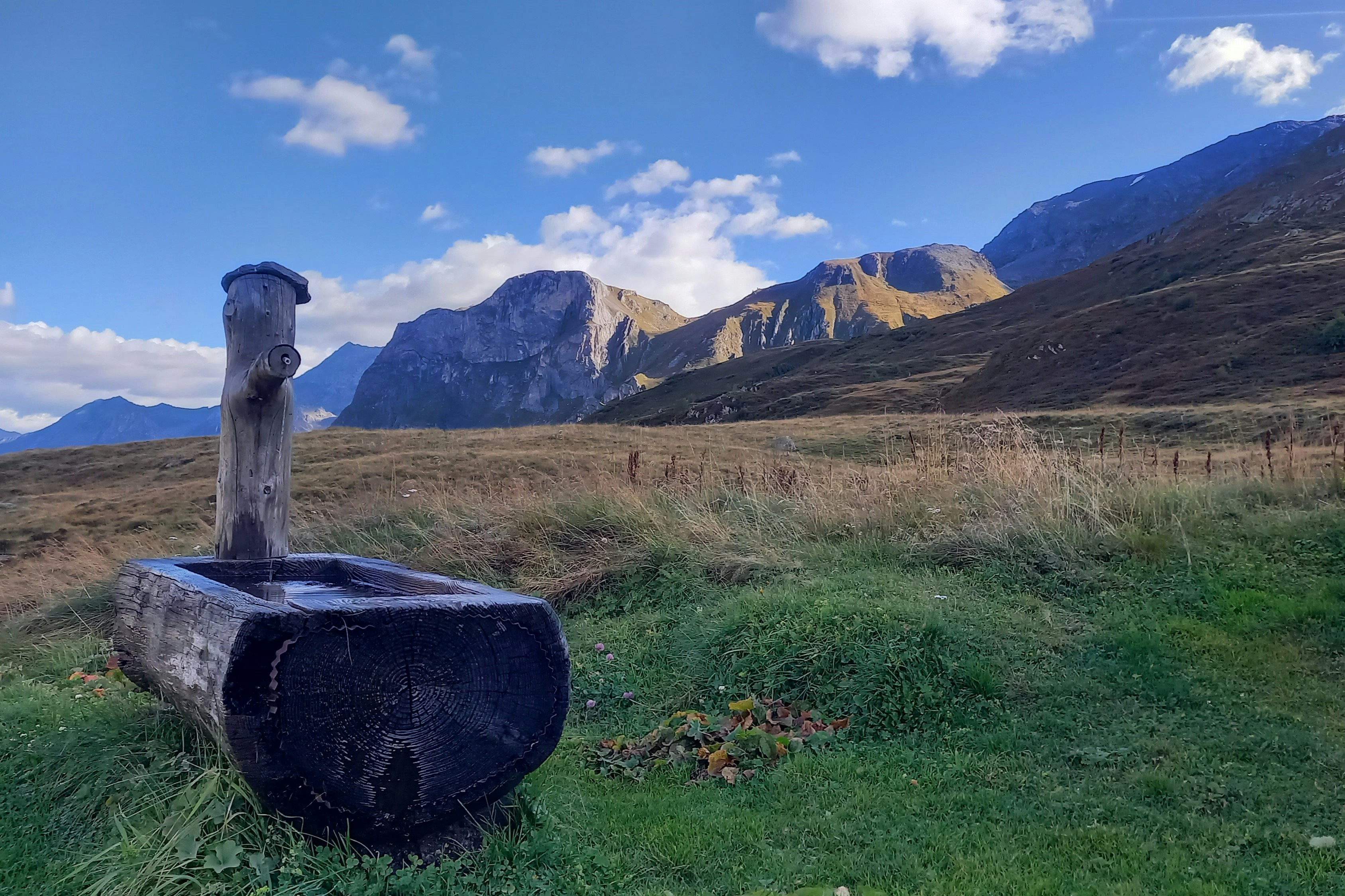 Wooden trough with water in a mountain landscape