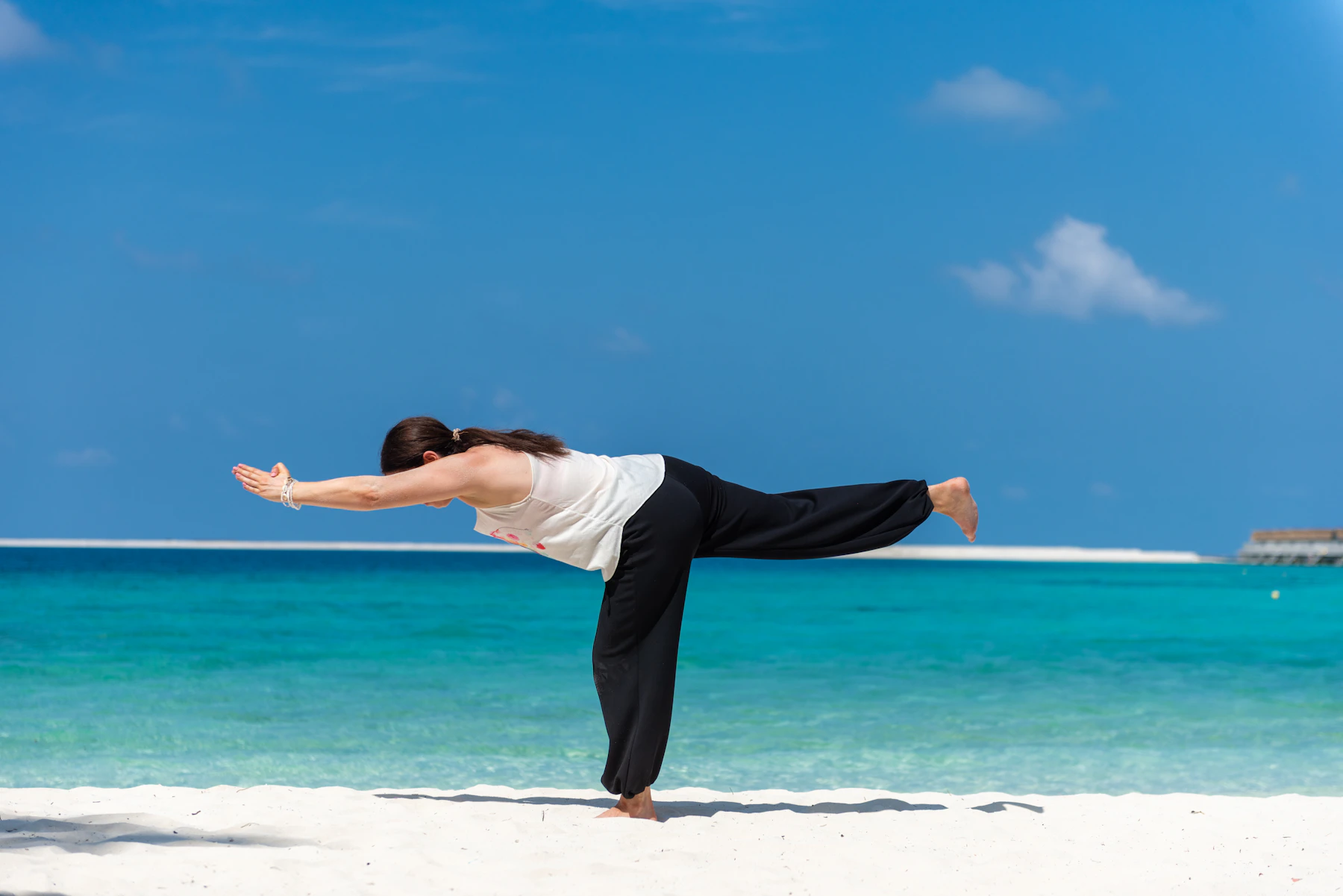 Práctica de yoga en un entorno tropical junto al mar