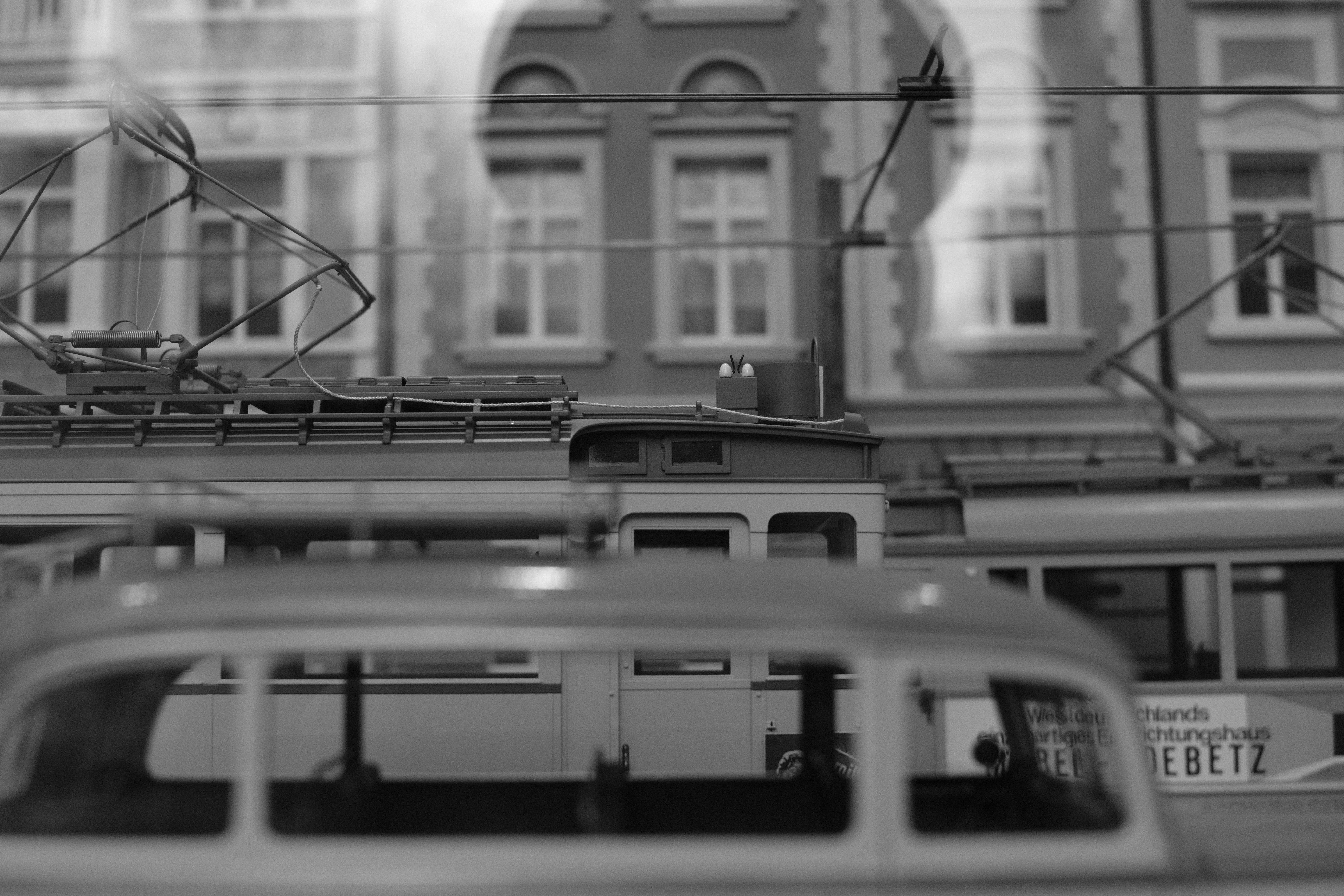 Black and white view of trams and buildings.