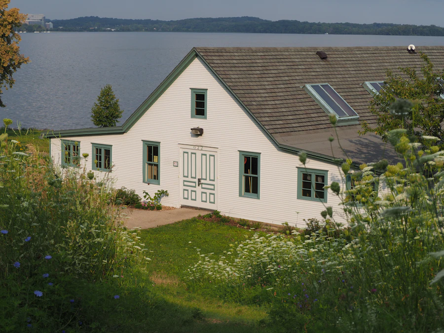 White house with green trim beside the water