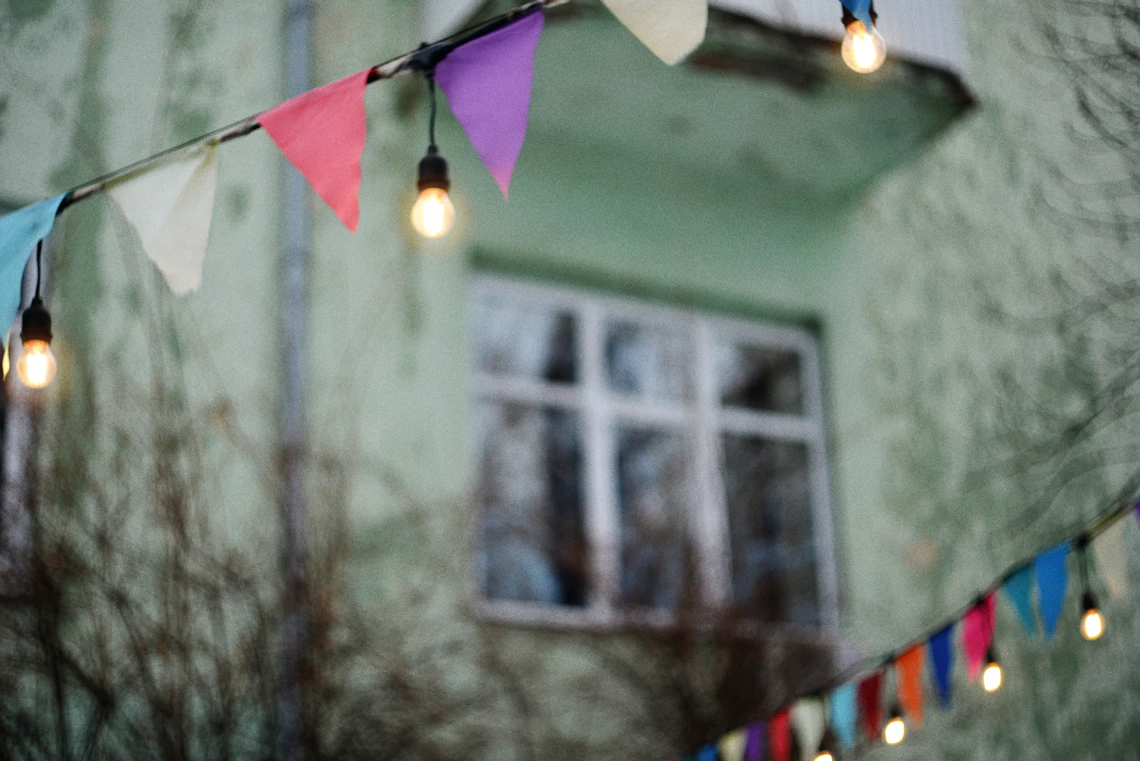 Colorful festive bunting and string lights creating an inviting outdoor celebration atmosphere