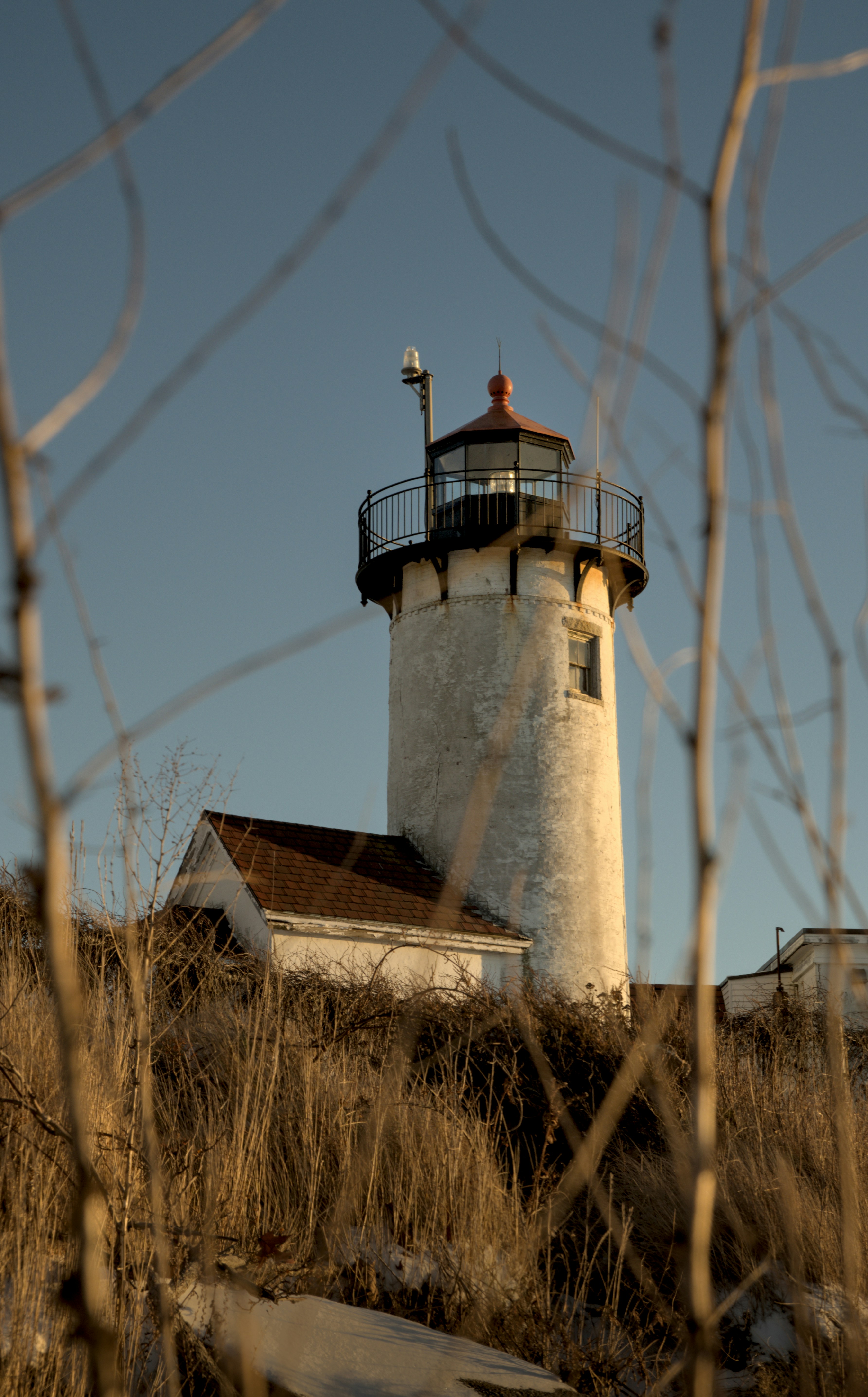 Lighthouse on a hill surrounded by dry grass
