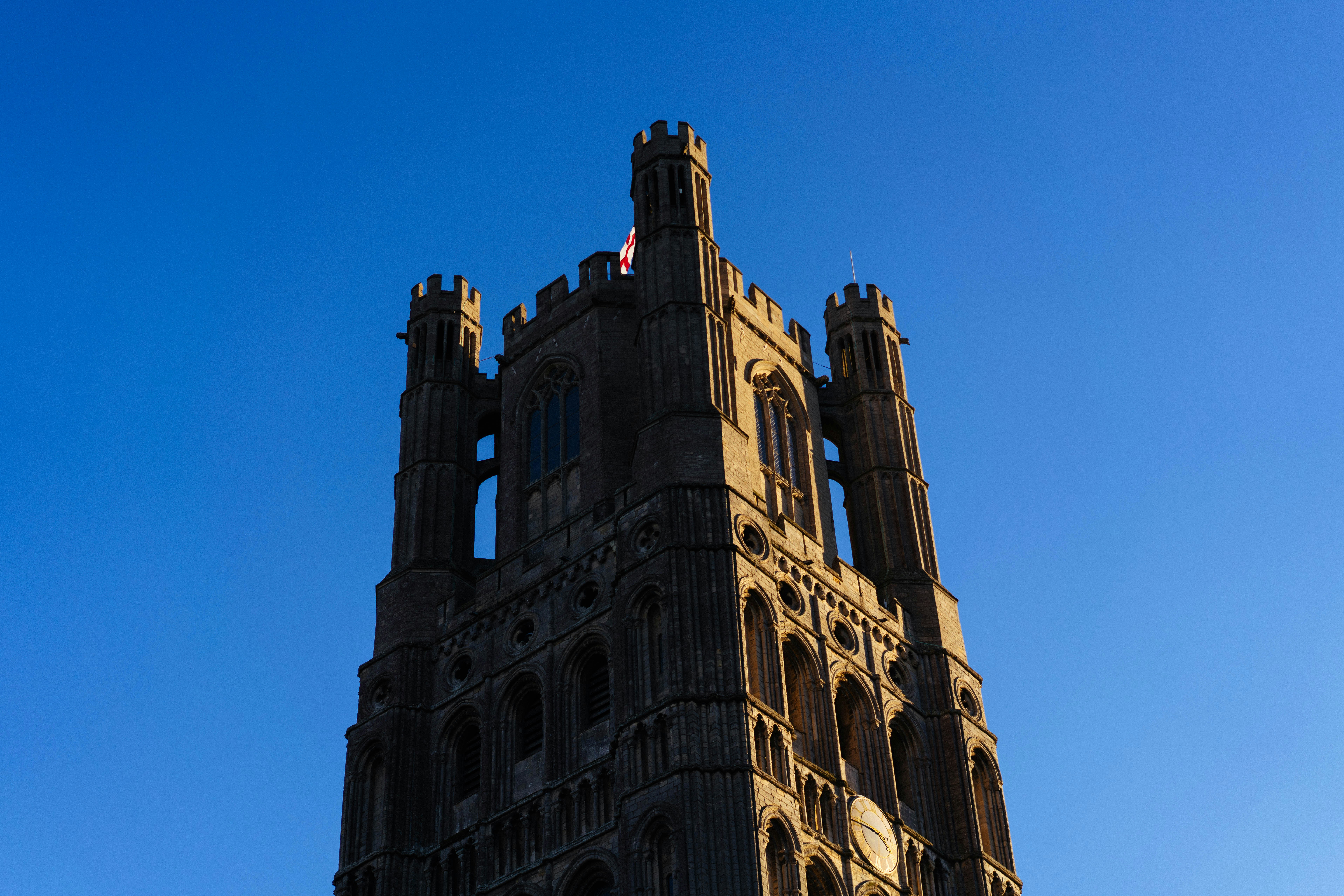 Stone cathedral tower against a clear blue sky
