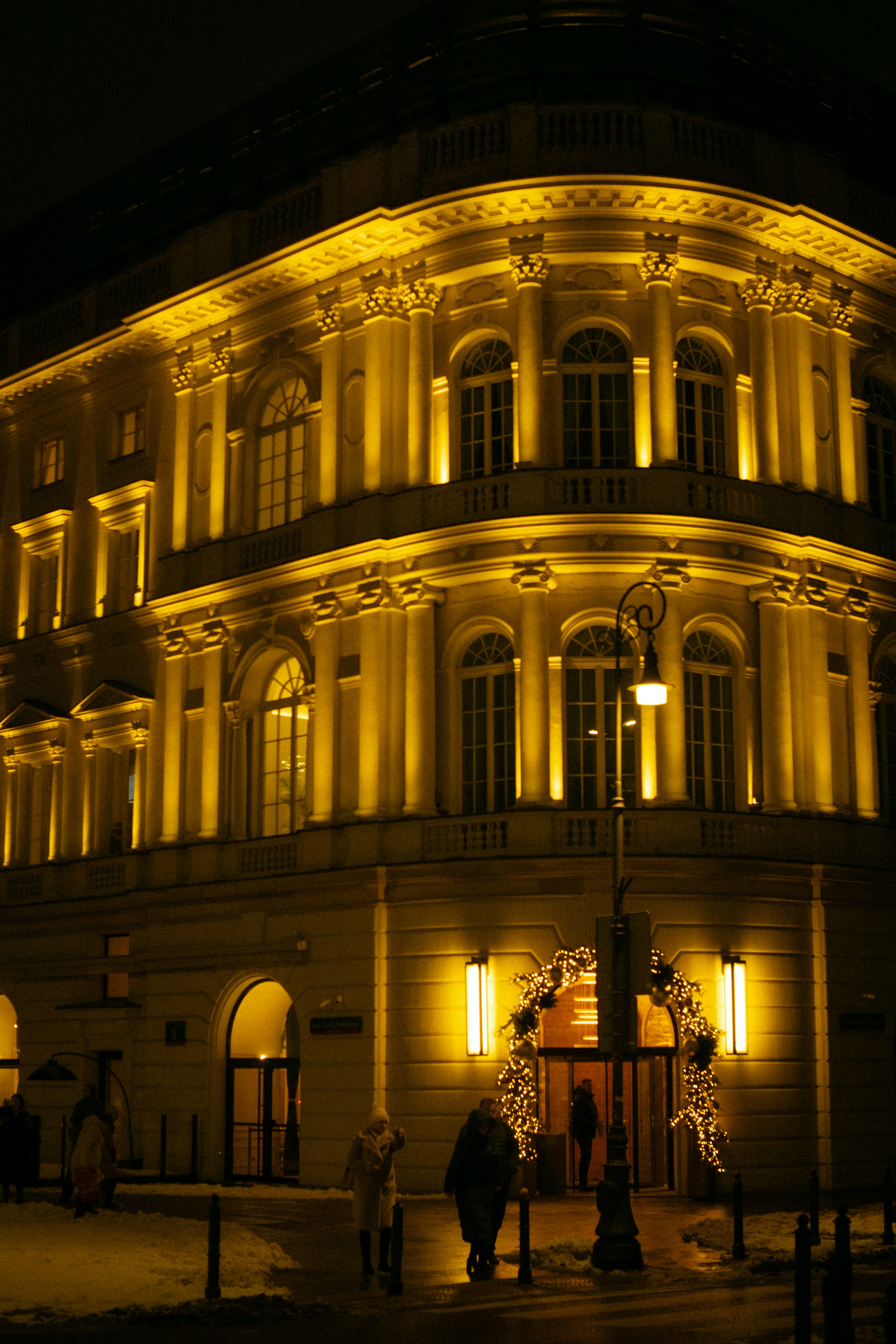 Ornate building illuminated with warm yellow lights at night.