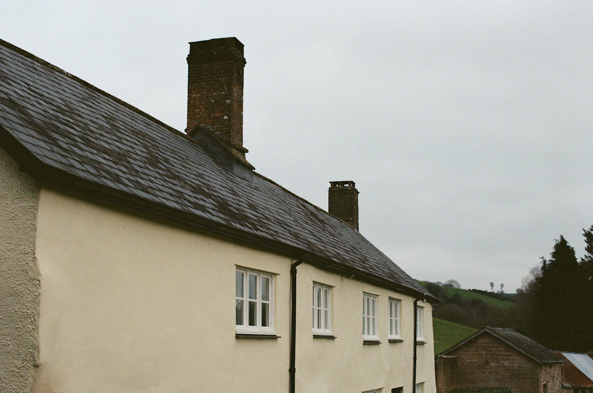 House with new dark roof and chimneys