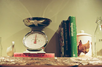 Kitchen scale with books and jars on shelf