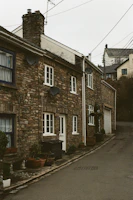 satellite dishes attached to stone houses which line a narrow, uphill street in lewes