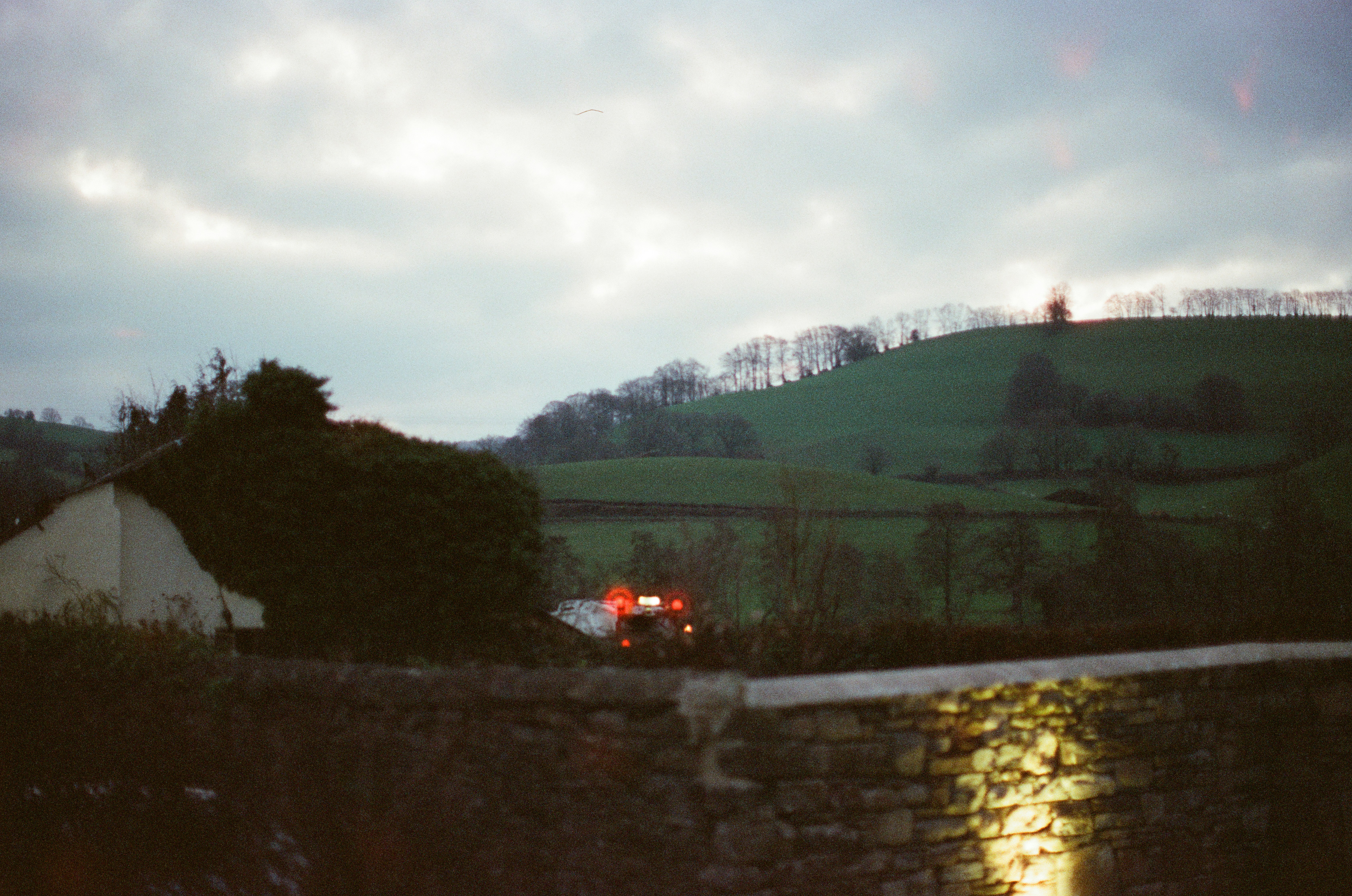 Fire truck with lights on near a hill