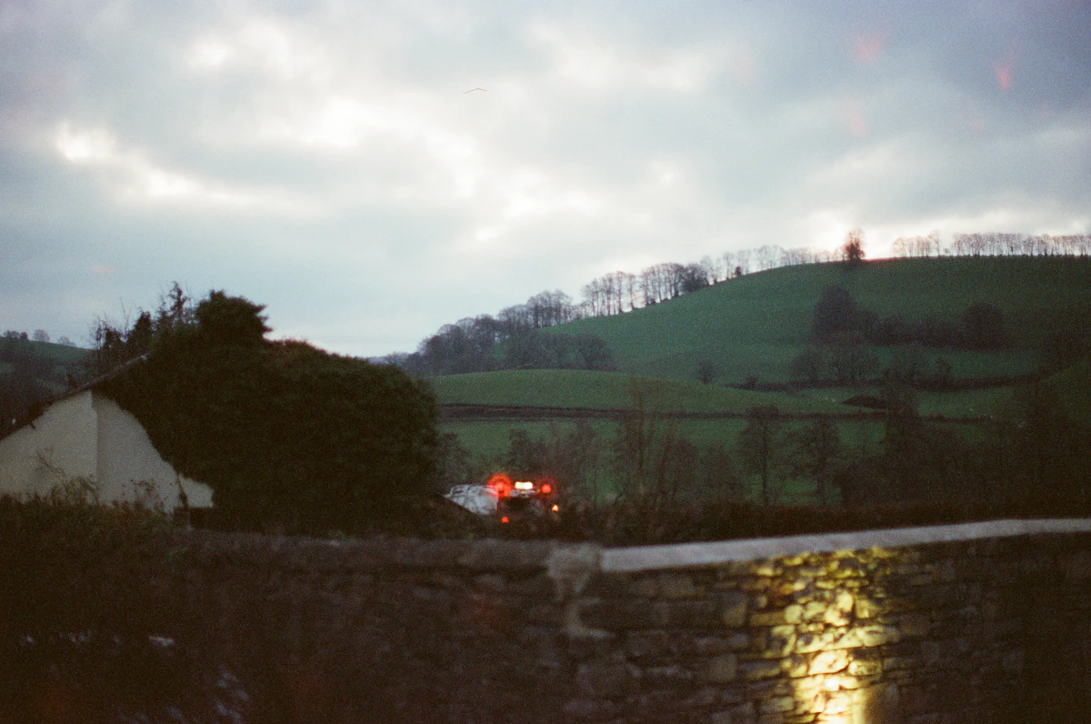 Fire truck with lights on near a hill