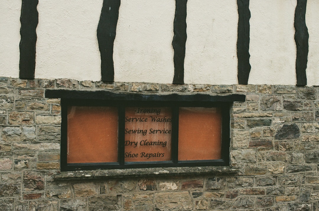 Window with sign for cleaning and repair services.