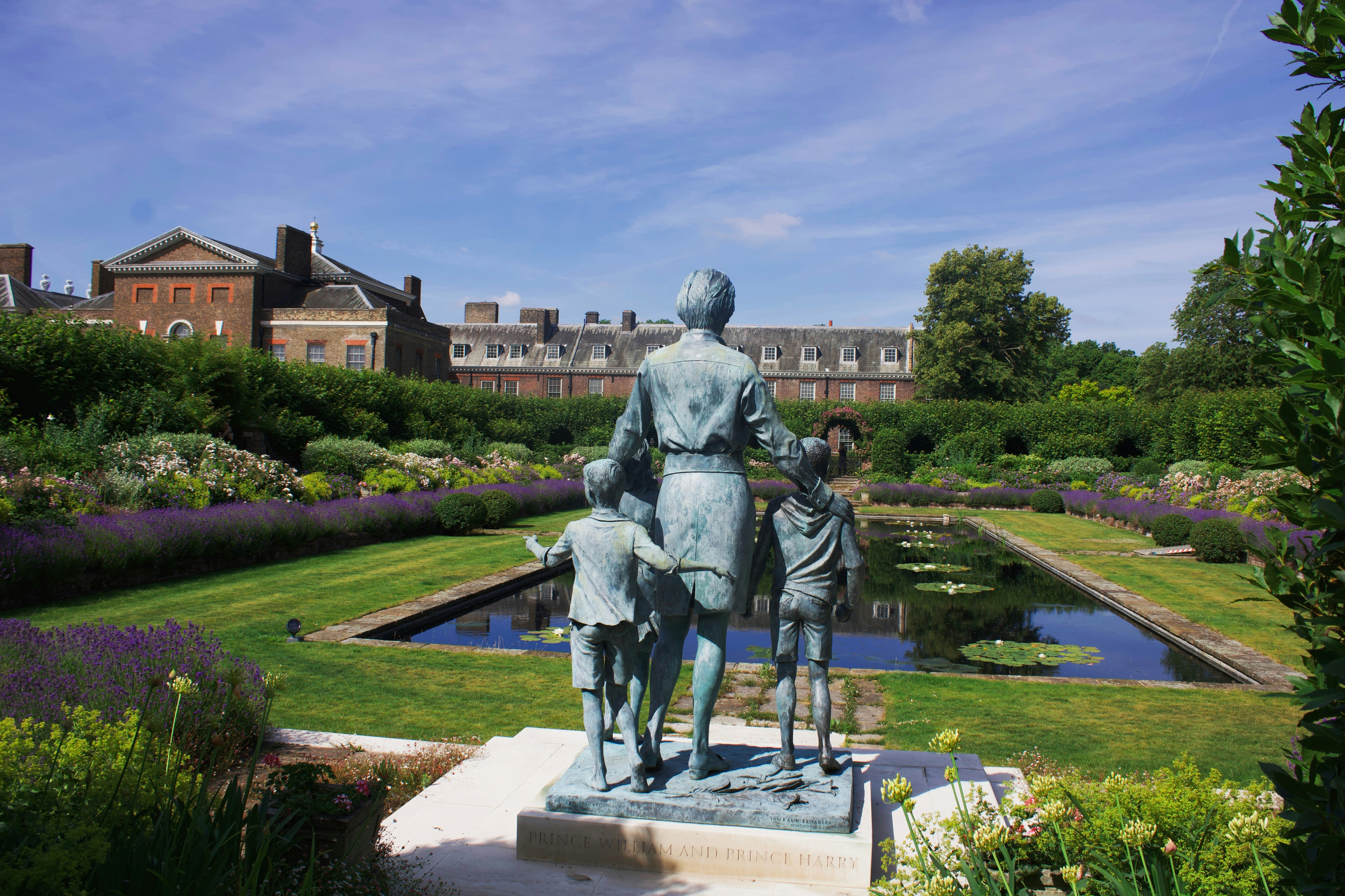 Statue of diana with her children in a garden.