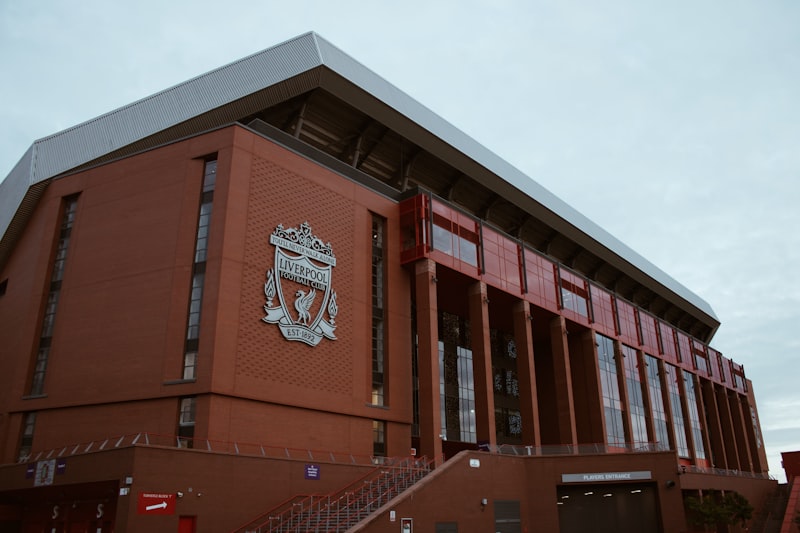 Exterior of a large brick stadium with a crest