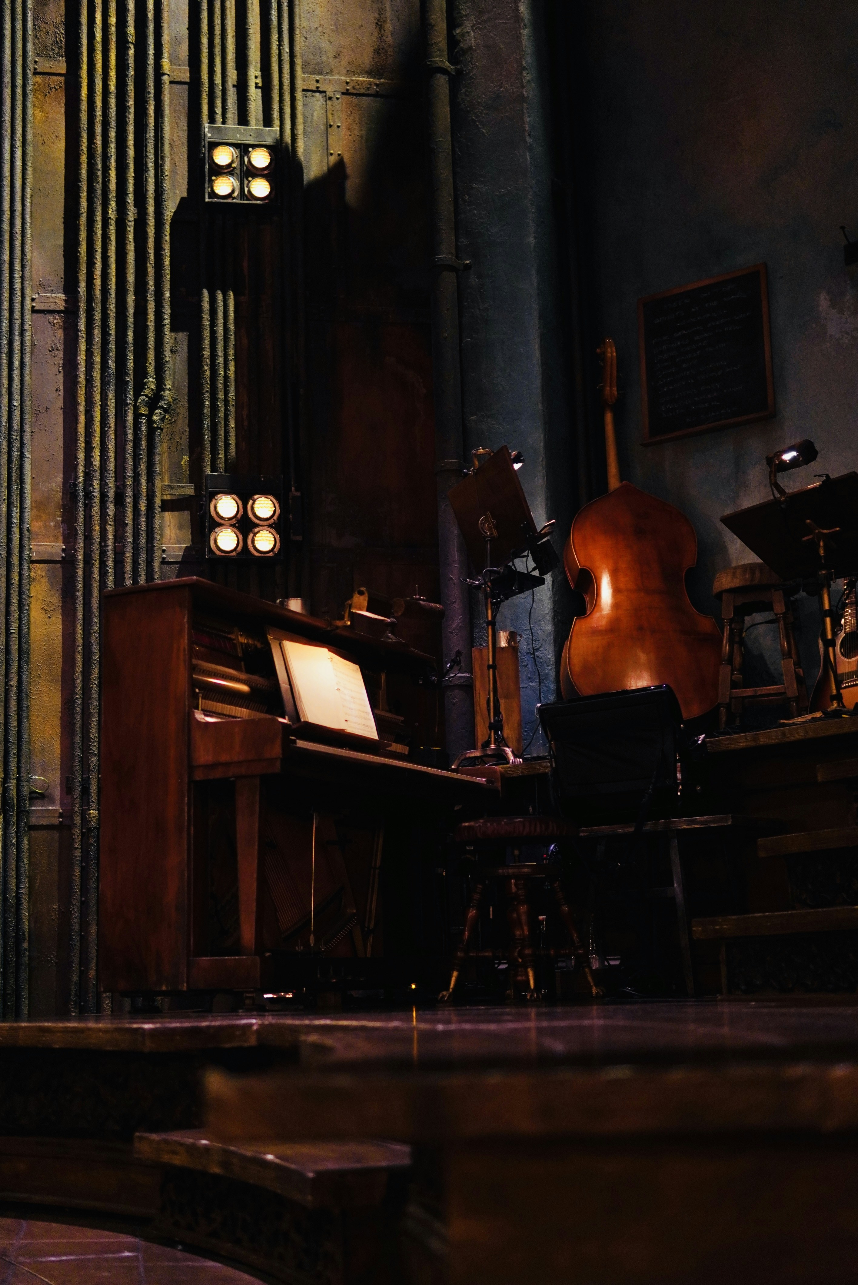 A piano and cello on a dimly lit stage.