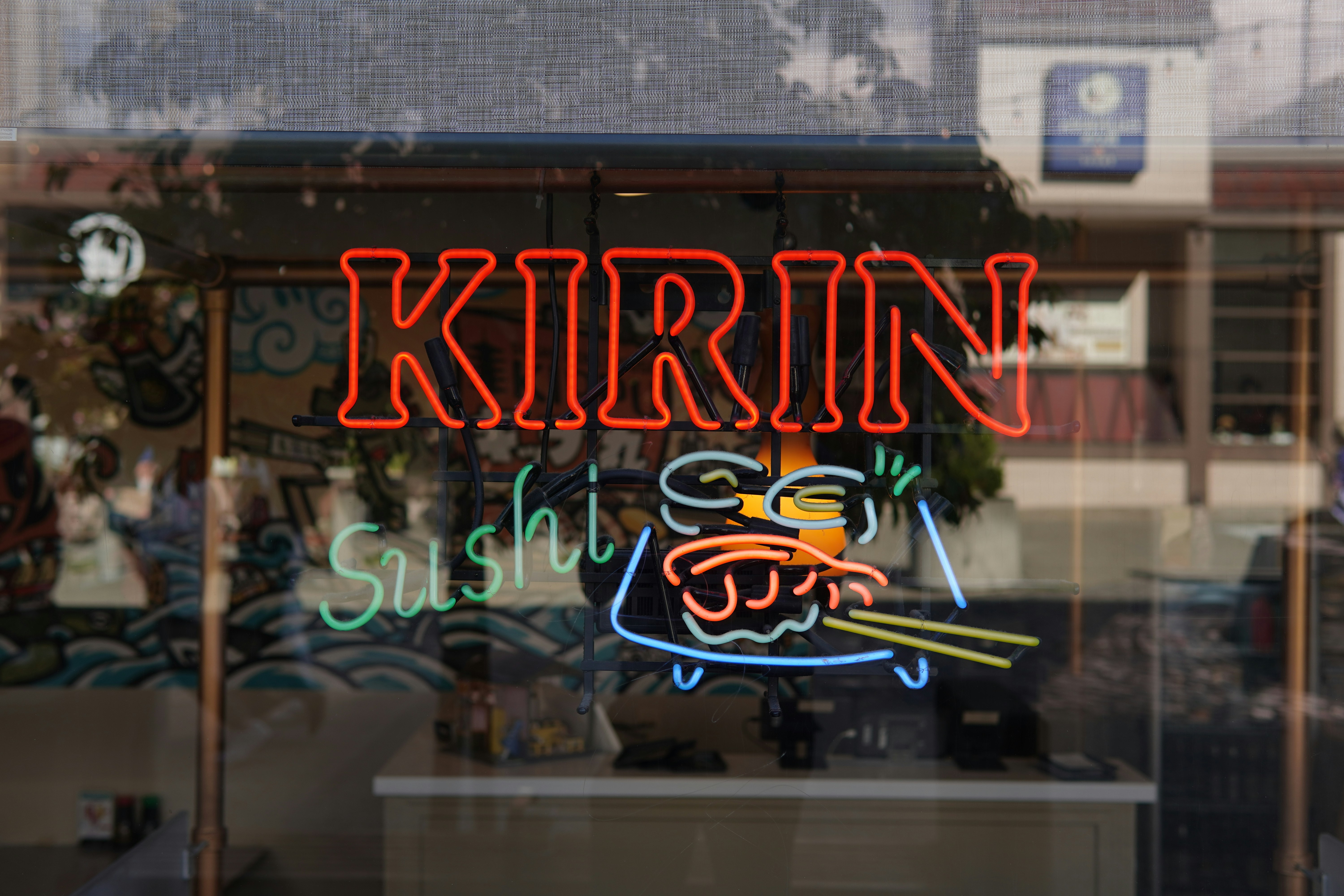 Kirin sushi neon sign on a glass storefront