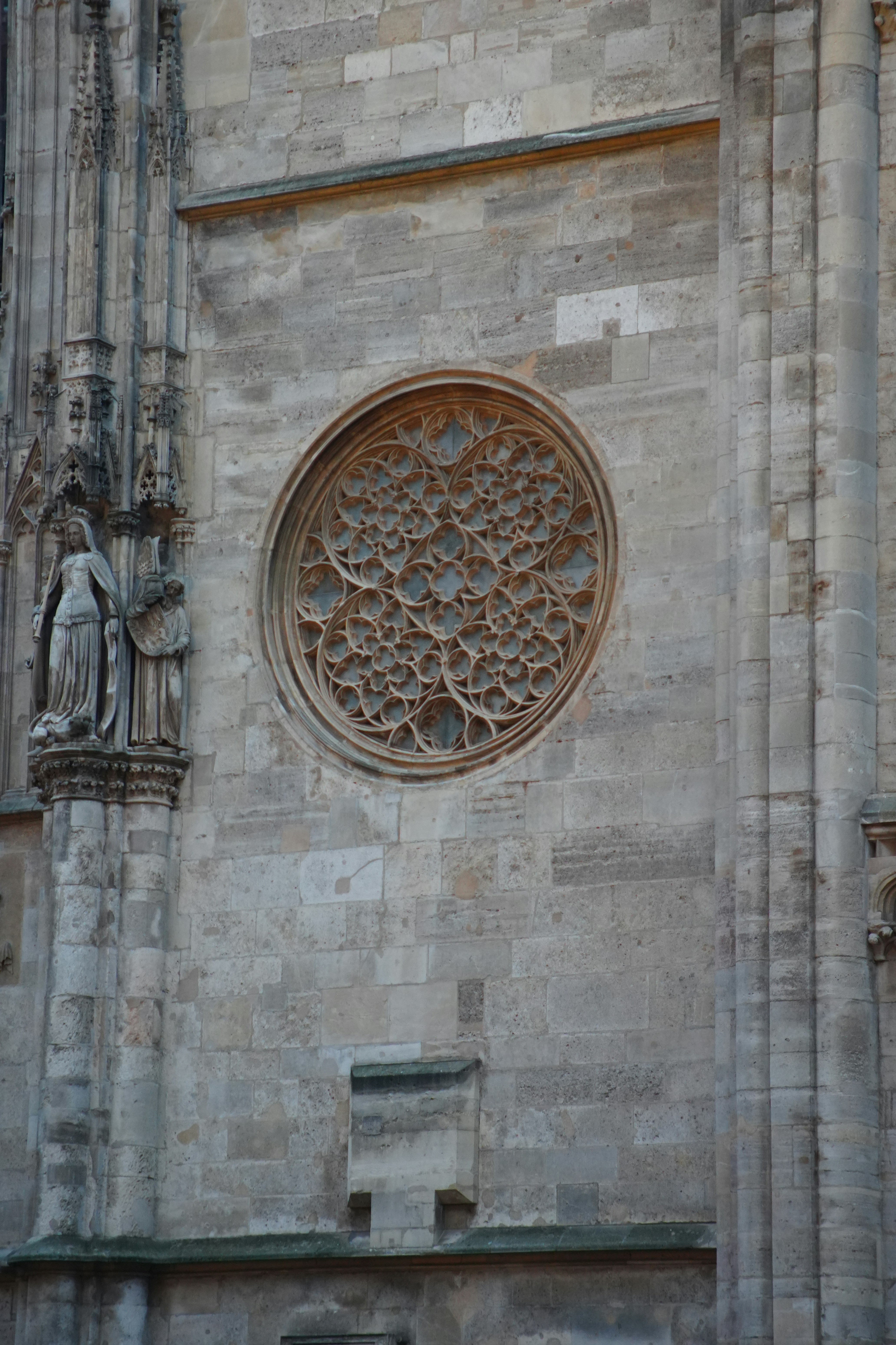 Fotomural Intricate rose window on an ancient stone cathedral wall