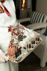 Server offers a tray of desserts and coffee