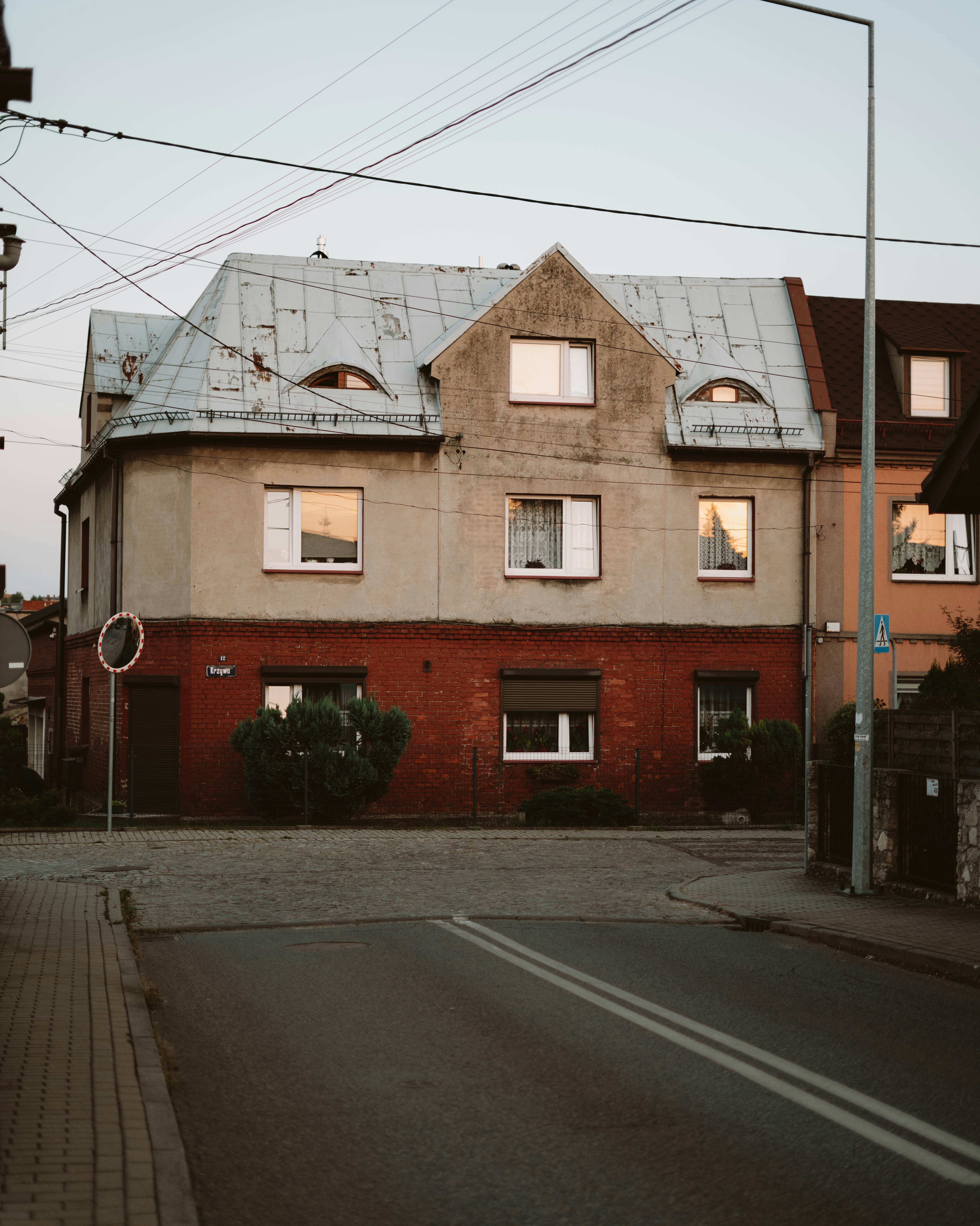 A weathered building with a red brick base.