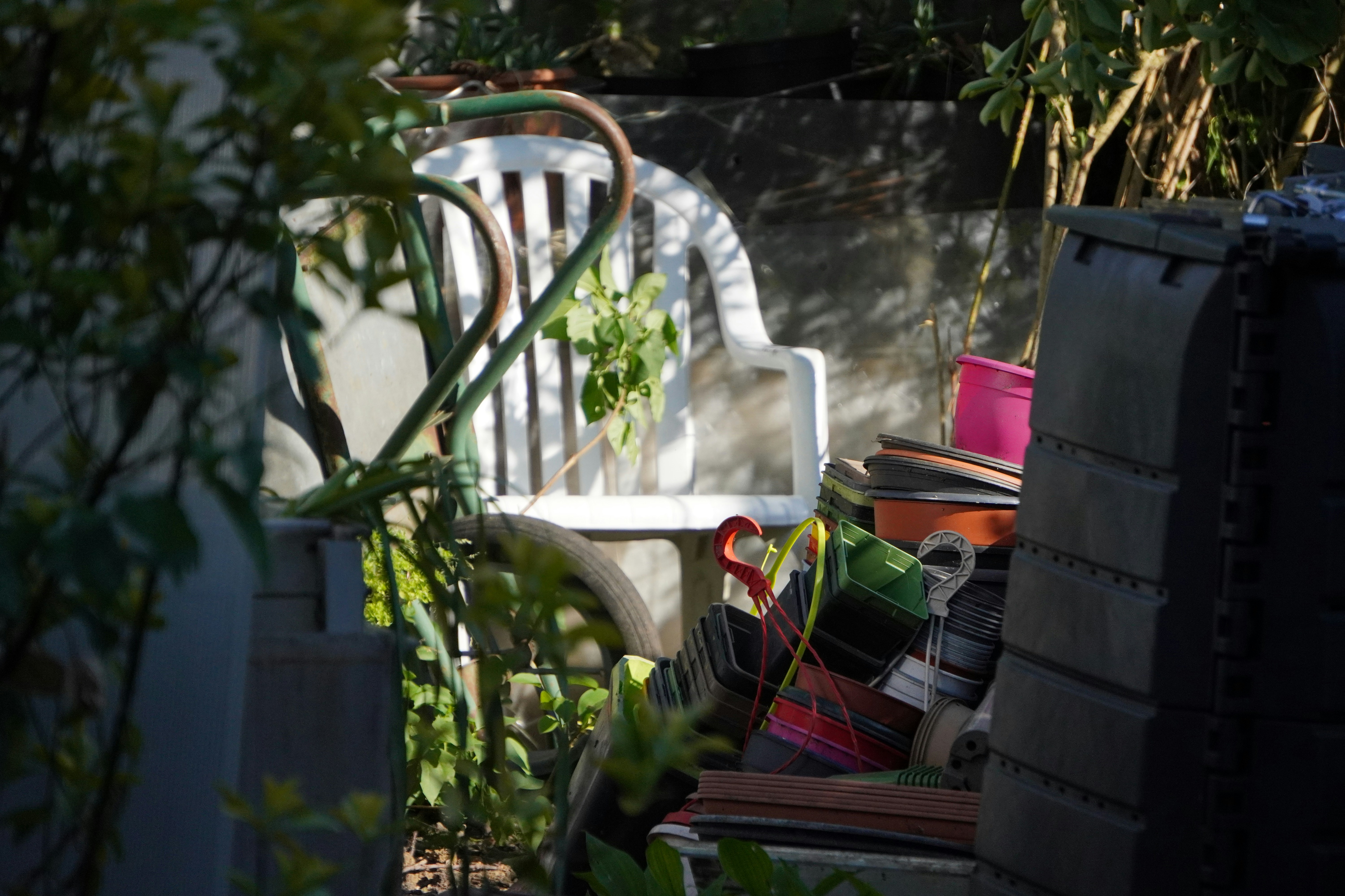 A variety of gardening tools and supplies displayed on a wooden table.